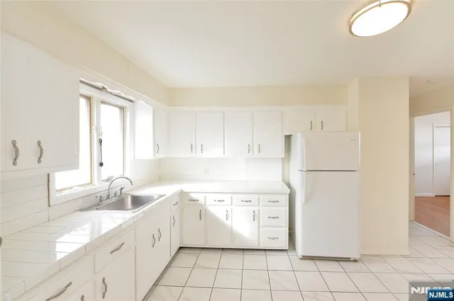 a kitchen with a white cabinets and white appliances