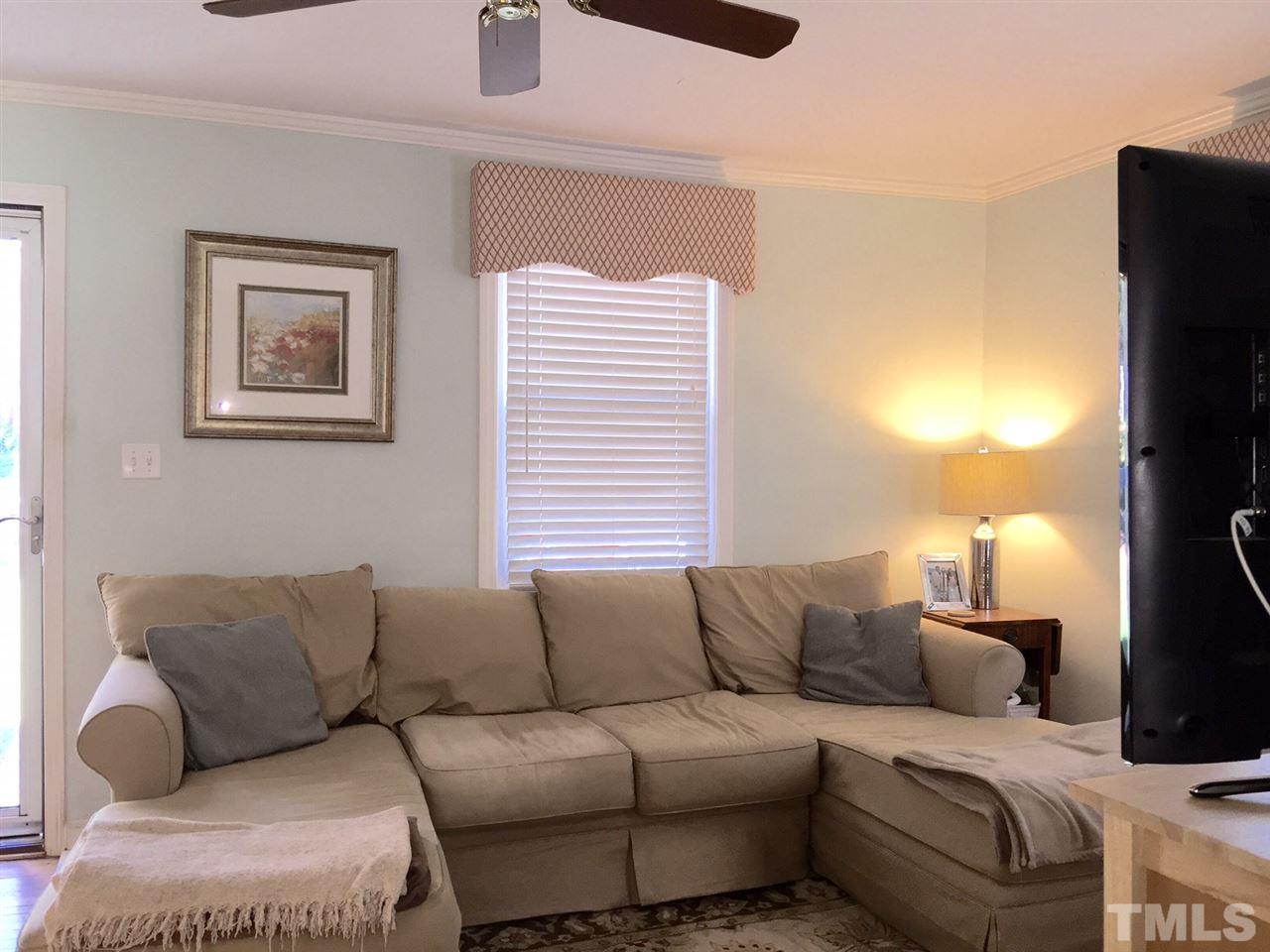 412 Colleton Road Raleigh, NC 27610 - Photo 2 of 19 a living room with furniture and a flat screen tv
