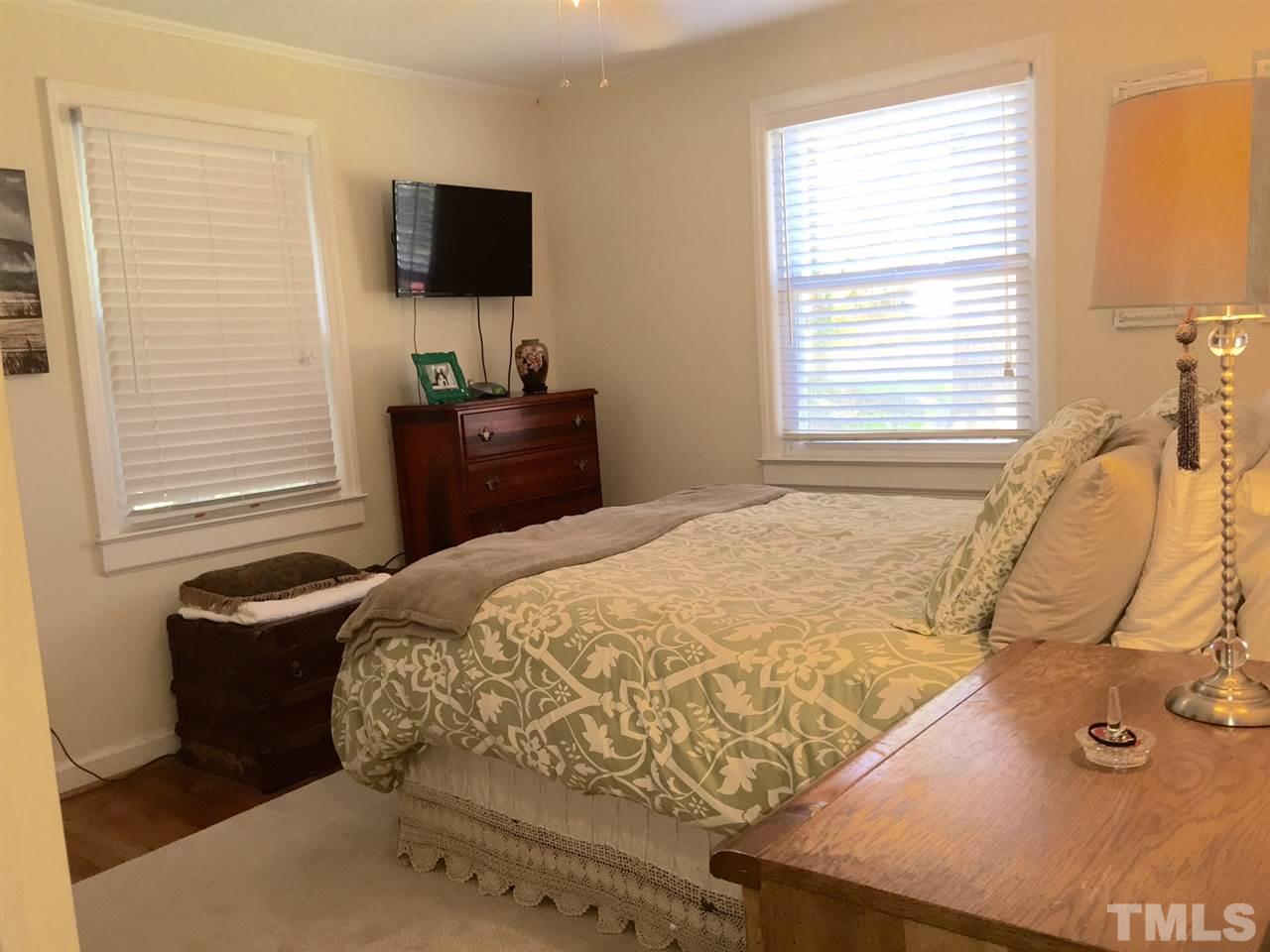 412 Colleton Road Raleigh, NC 27610 - Photo 13 of 19 a bedroom with a bed and a flat screen tv