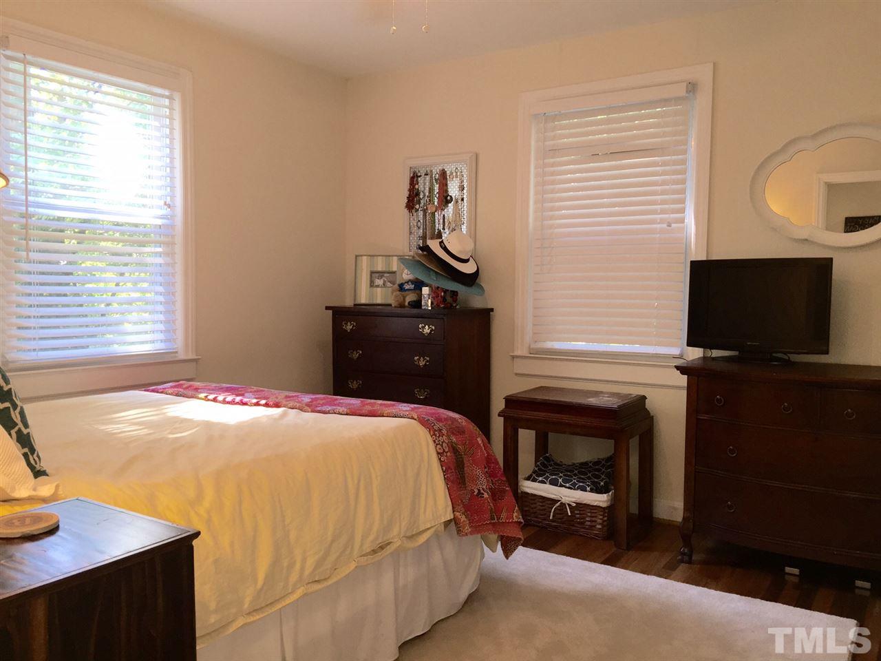 412 Colleton Road Raleigh, NC 27610 - Photo 14 of 19 a bedroom with a bed and a flat screen tv