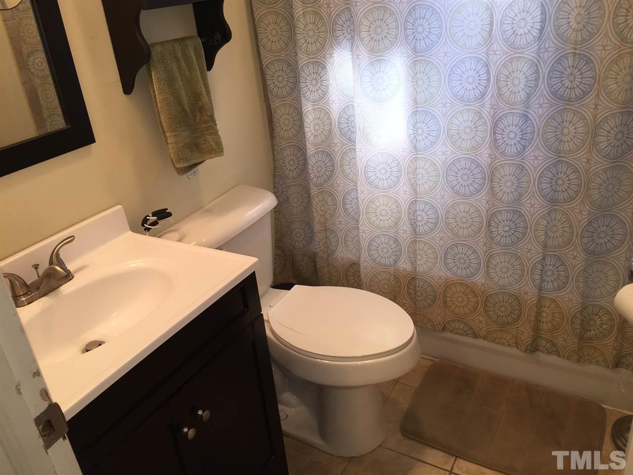 412 Colleton Road Raleigh, NC 27610 - Photo 16 of 19 a bathroom with a sink and a toilet