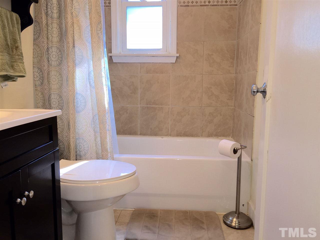412 Colleton Road Raleigh, NC 27610 - Photo 17 of 19 a bathroom with a sink a toilet and a bathtub