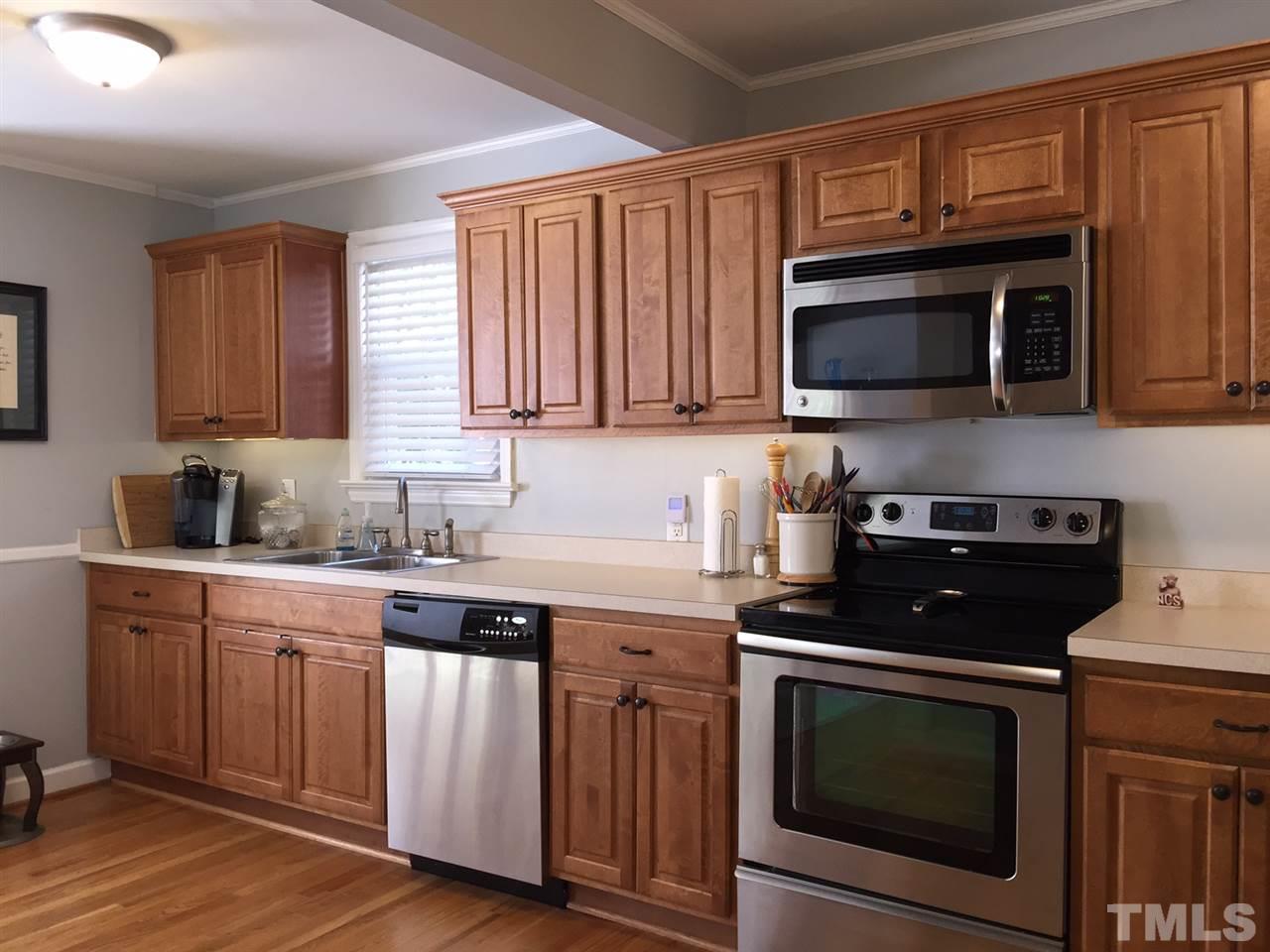 412 Colleton Road Raleigh, NC 27610 - Photo 8 of 19 a kitchen with cabinets stainless steel appliances a sink and a microwave