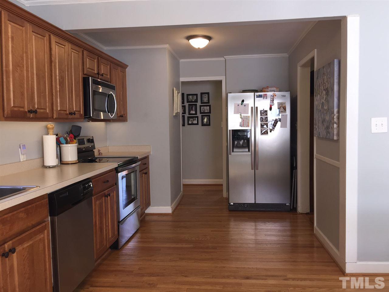 412 Colleton Road Raleigh, NC 27610 - Photo 10 of 19 a kitchen with stainless steel appliances granite countertop a refrigerator a sink and wooden cabinets
