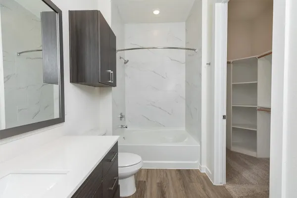 a bathroom with a bathtub a toilet and a shower