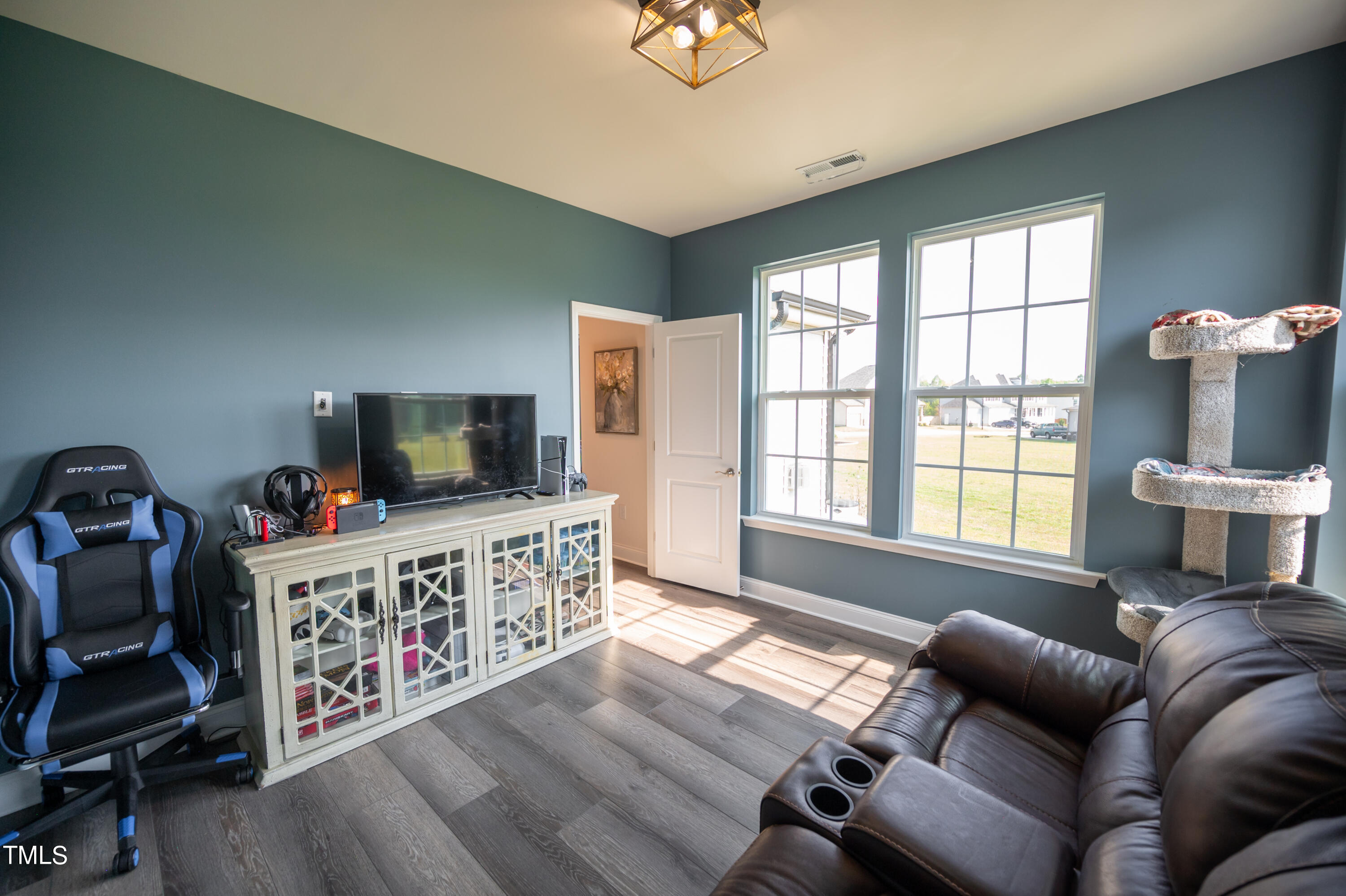 357 Sunrise Ridge Drive Willow Spring, NC 27592 - Photo 14 of 35 a living room with furniture and a flat screen tv