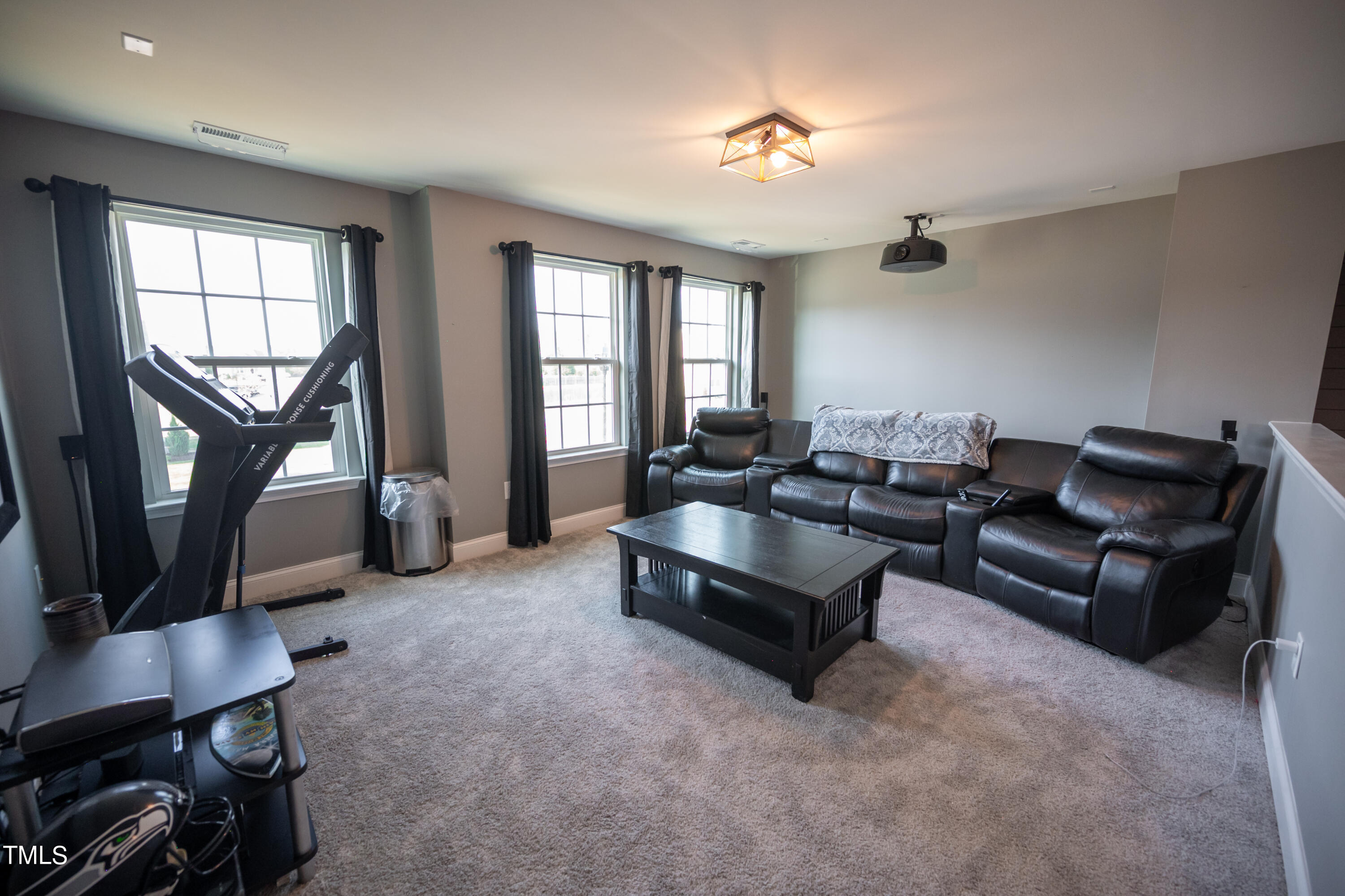 357 Sunrise Ridge Drive Willow Spring, NC 27592 - Photo 17 of 35 a living room with furniture a fireplace and a window