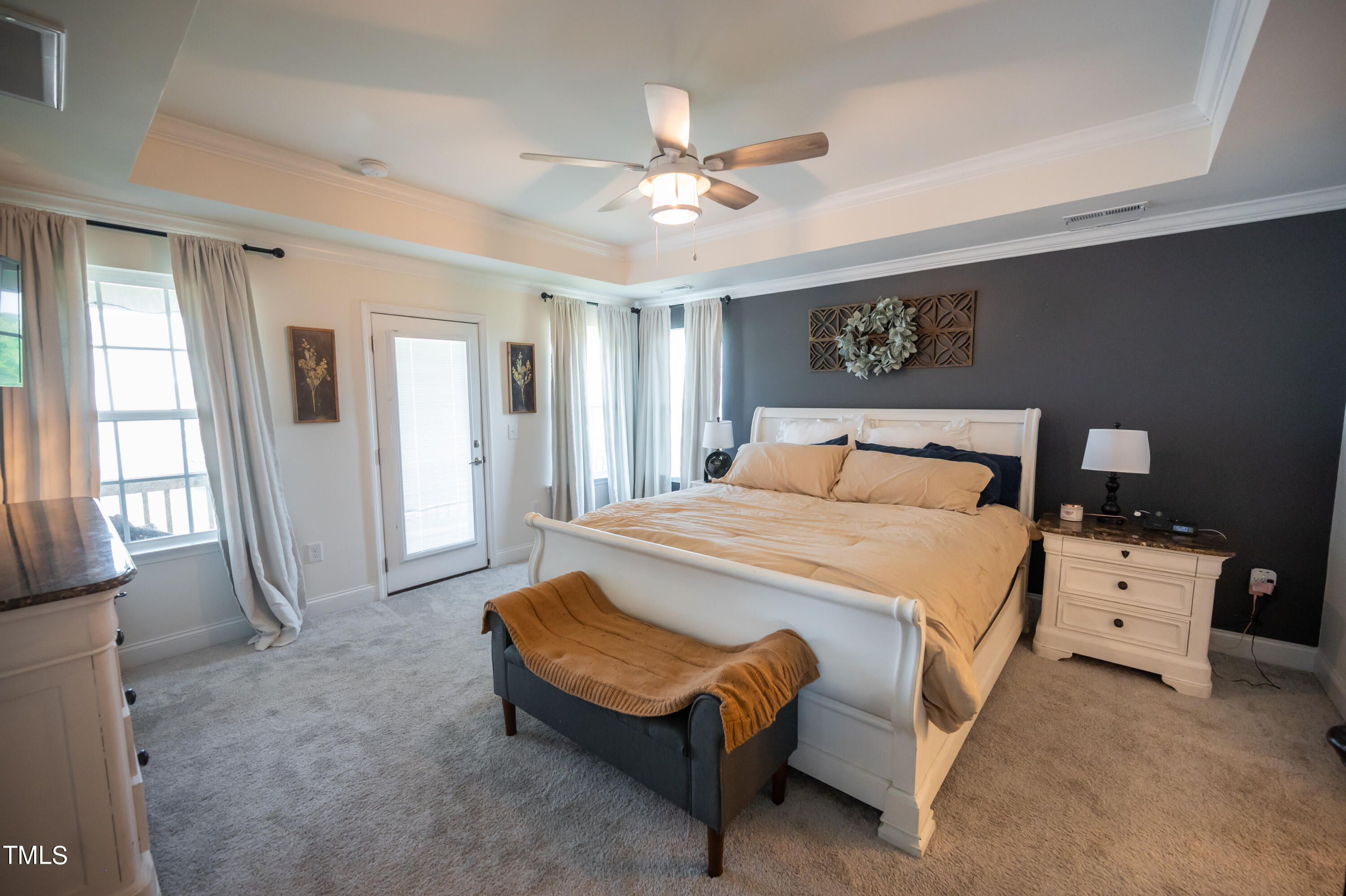 357 Sunrise Ridge Drive Willow Spring, NC 27592 - Photo 19 of 35 a bedroom with a bed and a chandelier