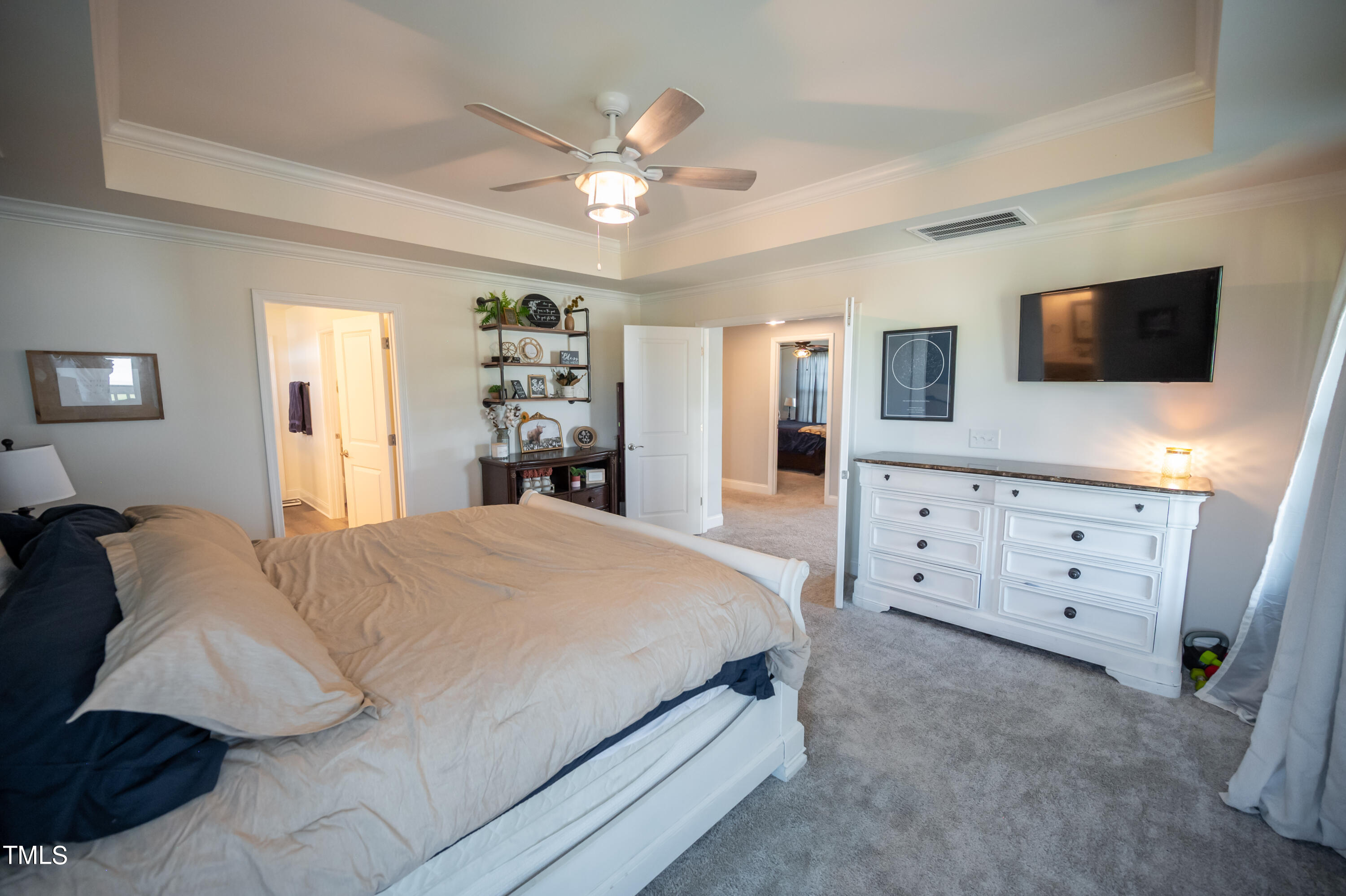 357 Sunrise Ridge Drive Willow Spring, NC 27592 - Photo 20 of 35 a spacious bedroom with a large bed and a flat tv screen on dresser