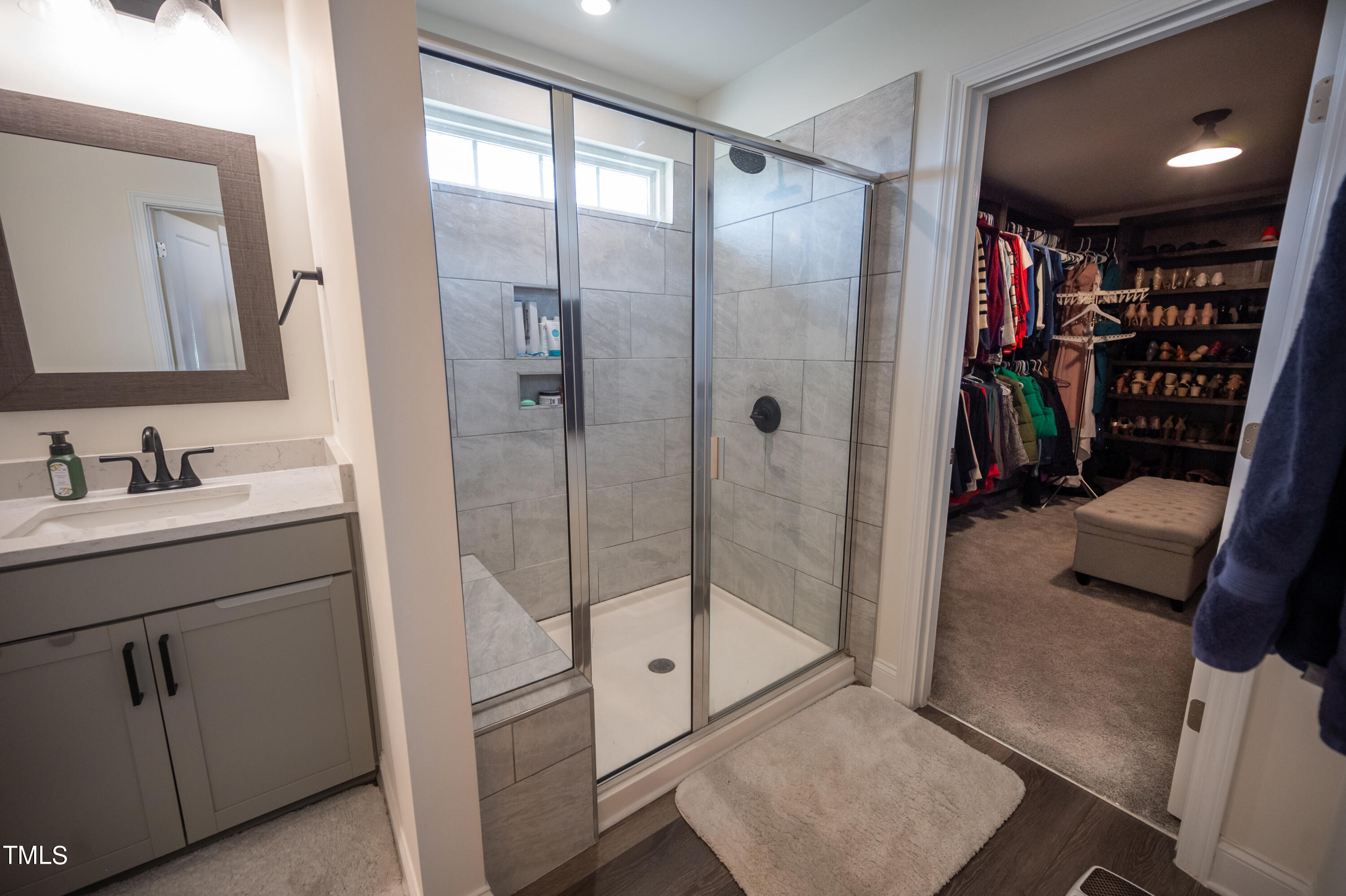 357 Sunrise Ridge Drive Willow Spring, NC 27592 - Photo 21 of 35 a bathroom with a shower sink and mirror