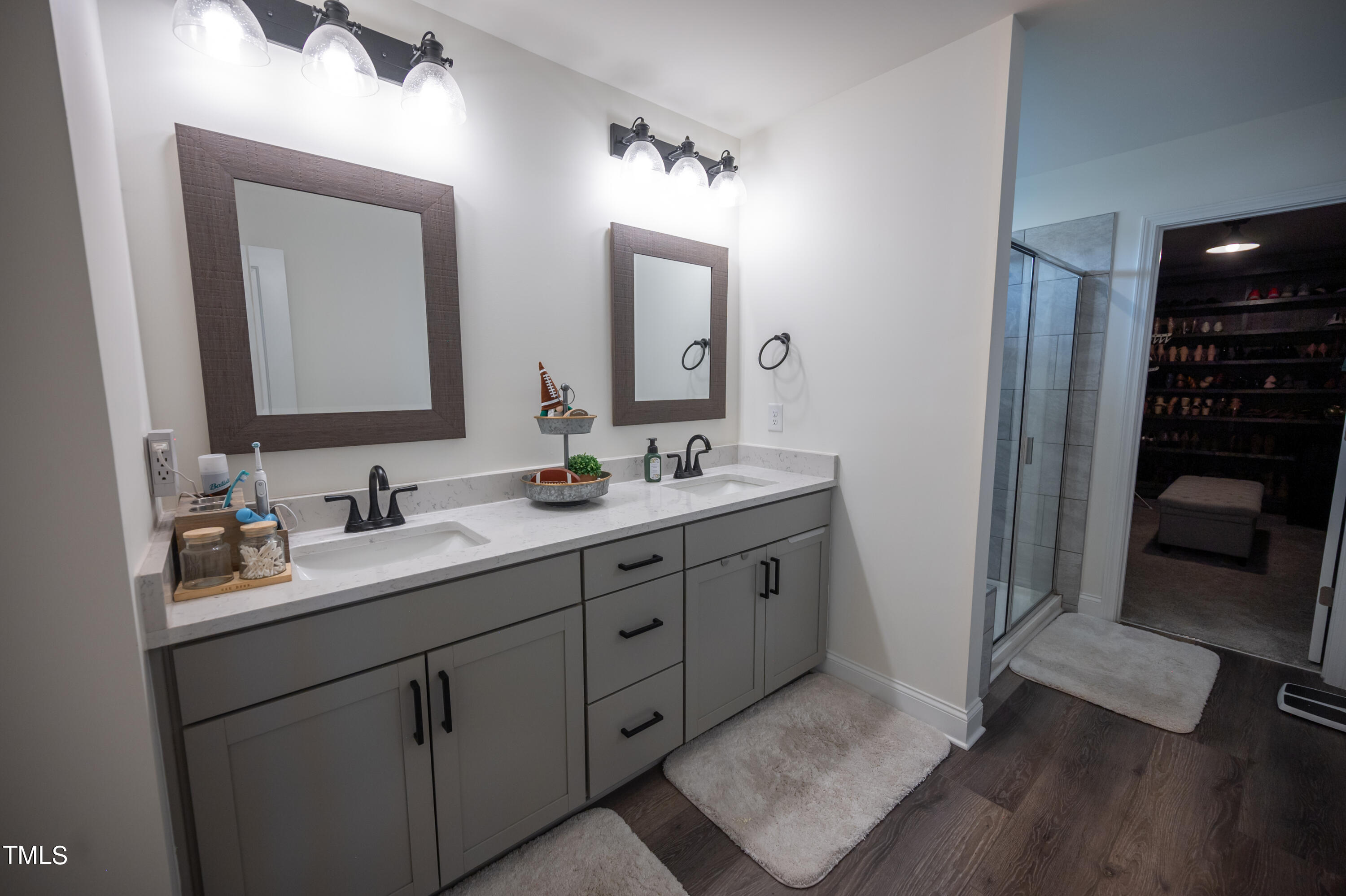 357 Sunrise Ridge Drive Willow Spring, NC 27592 - Photo 22 of 35 a bathroom with a double vanity sink and mirror