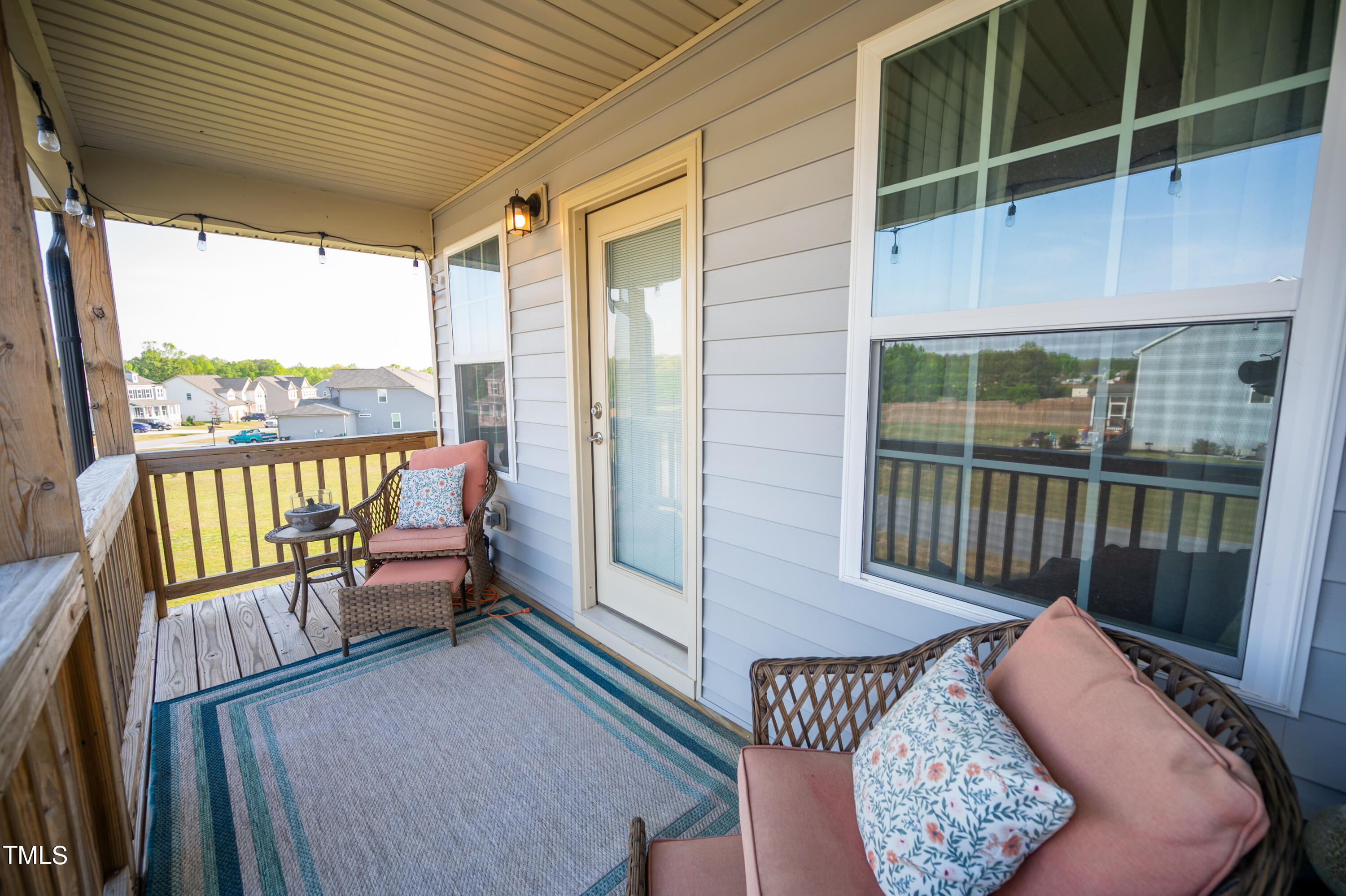357 Sunrise Ridge Drive Willow Spring, NC 27592 - Photo 25 of 35 a balcony with furniture and a potted plant