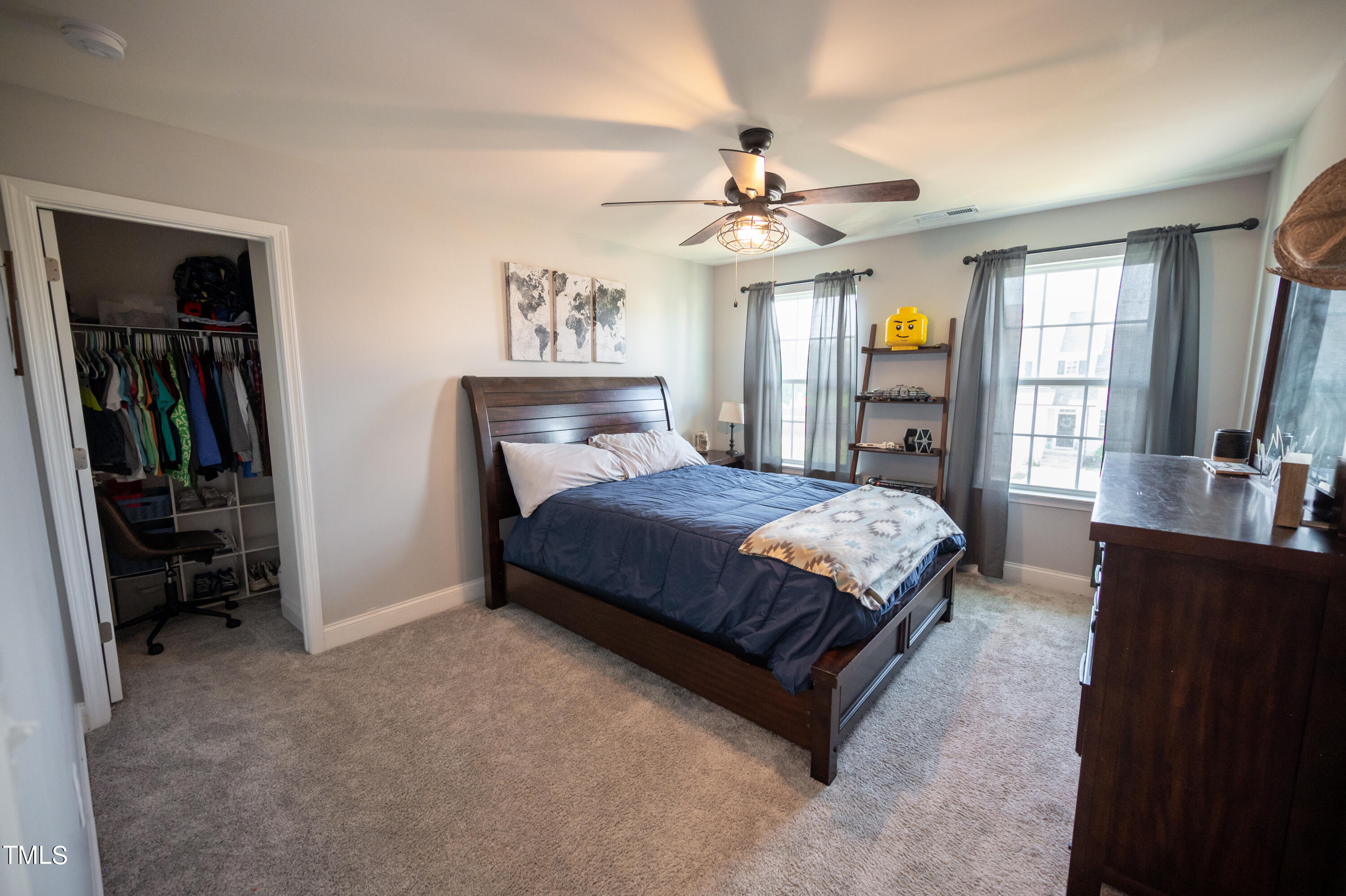357 Sunrise Ridge Drive Willow Spring, NC 27592 - Photo 26 of 35 a bedroom with a large bed a chandelier and dresser