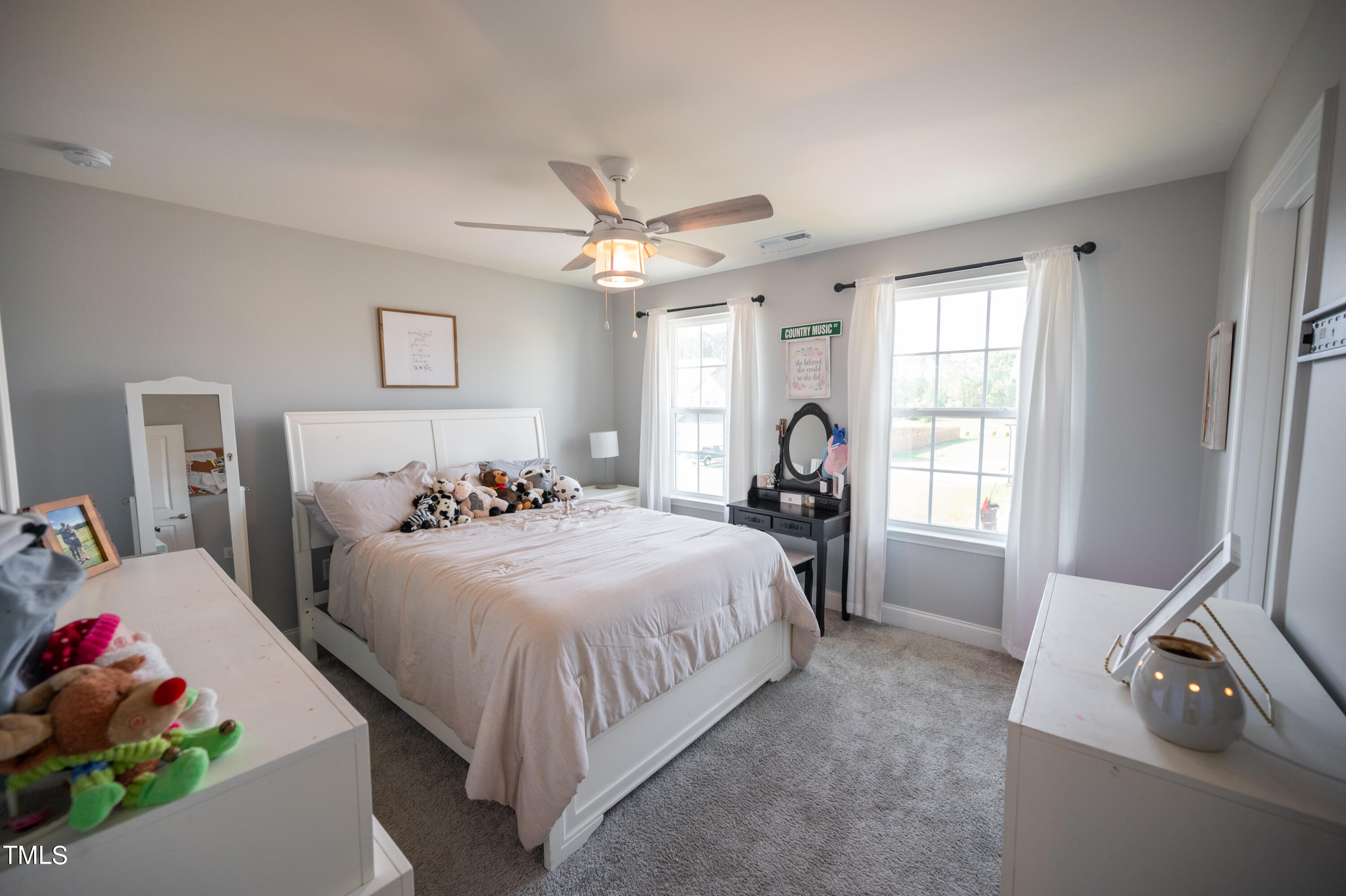 357 Sunrise Ridge Drive Willow Spring, NC 27592 - Photo 27 of 35 a bed room with a bed and a chandelier