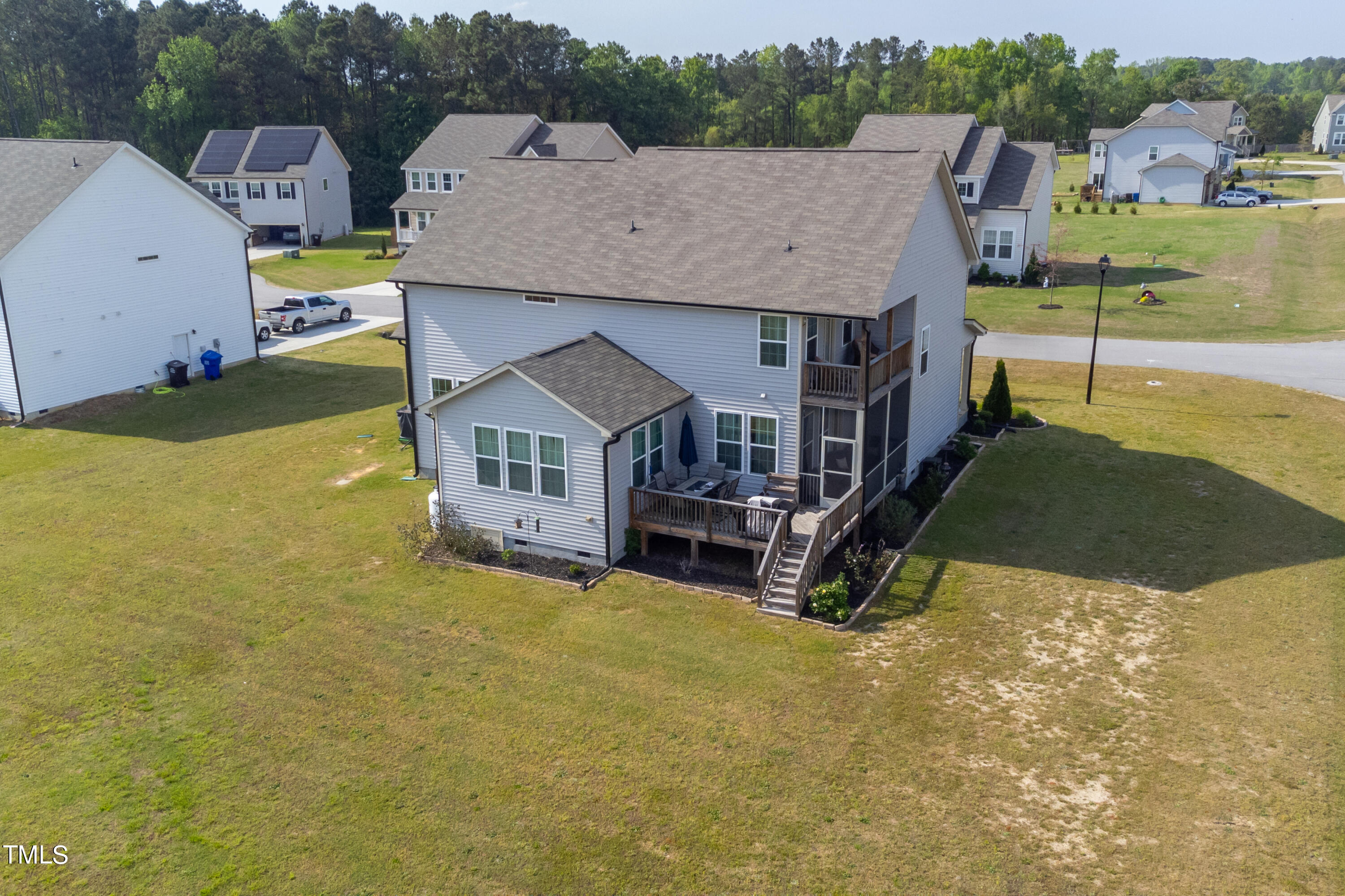 357 Sunrise Ridge Drive Willow Spring, NC 27592 - Photo 3 of 35 an aerial view of a house with swimming pool and large trees