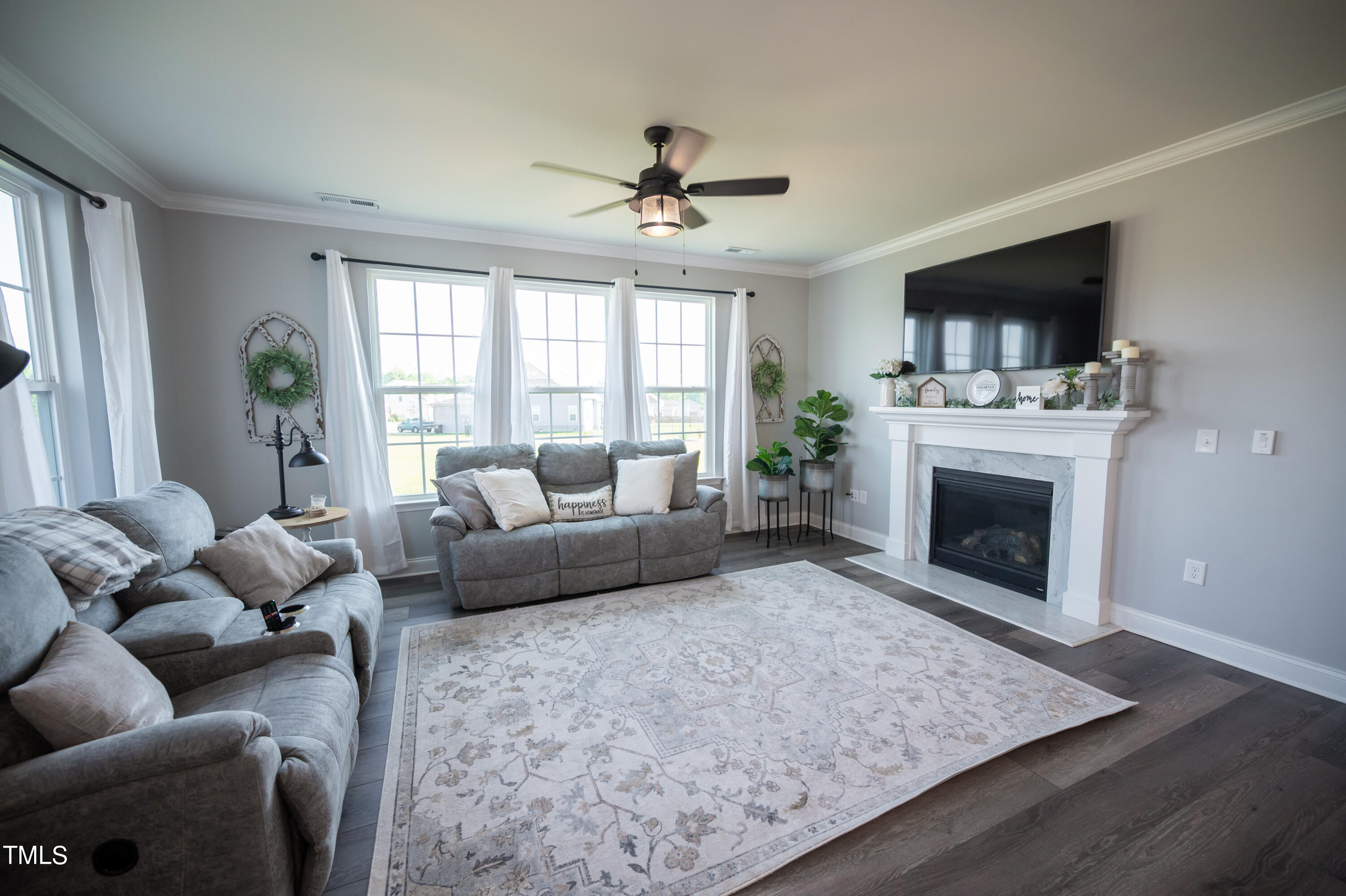 357 Sunrise Ridge Drive Willow Spring, NC 27592 - Photo 5 of 35 a living room with furniture a flat screen tv and a fireplace