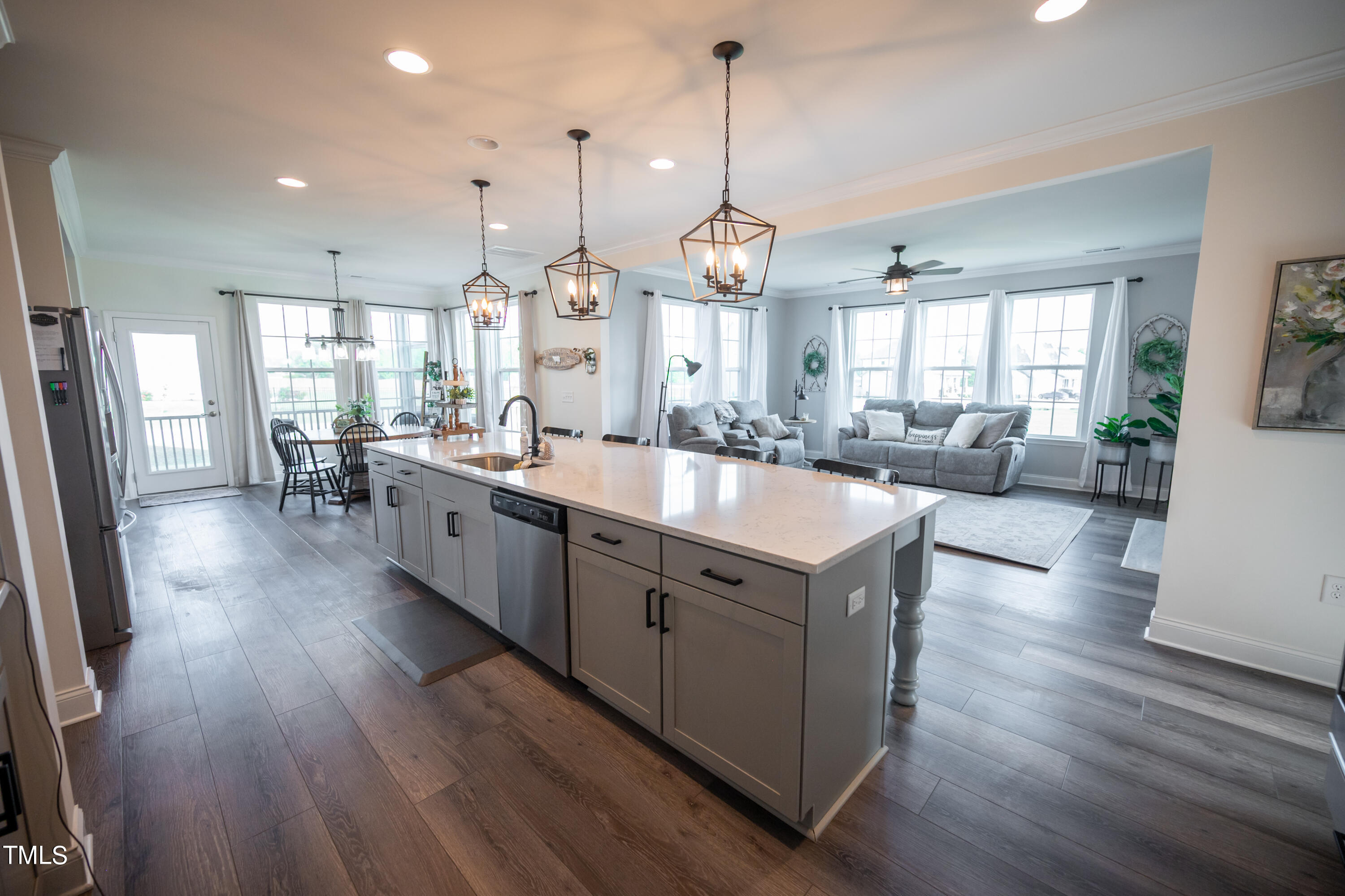 357 Sunrise Ridge Drive Willow Spring, NC 27592 - Photo 8 of 35 a large kitchen with kitchen island a large counter space a sink a window and stainless steel appliances