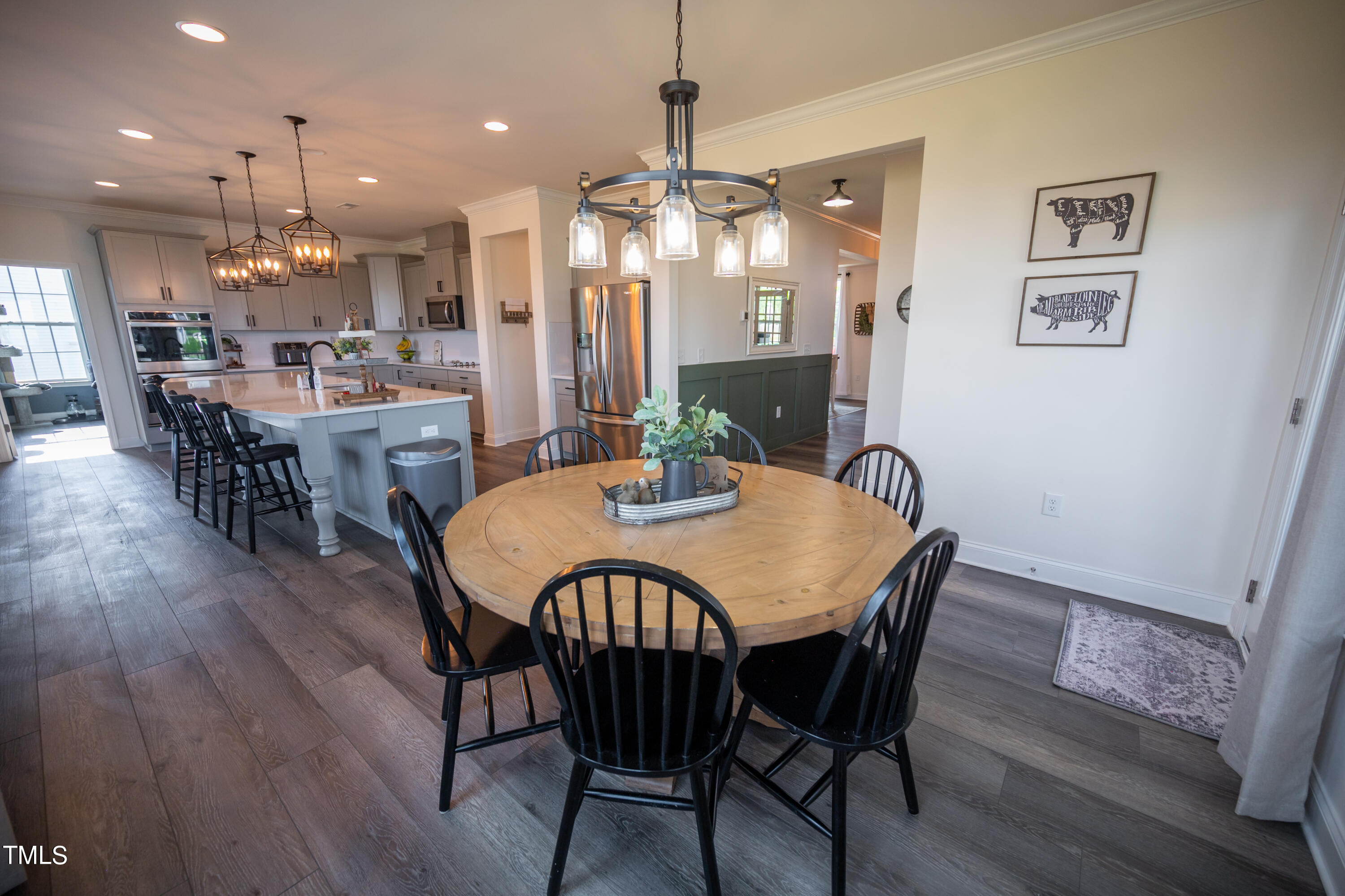 357 Sunrise Ridge Drive Willow Spring, NC 27592 - Photo 9 of 35 a dining room with furniture a chandelier and wooden floor