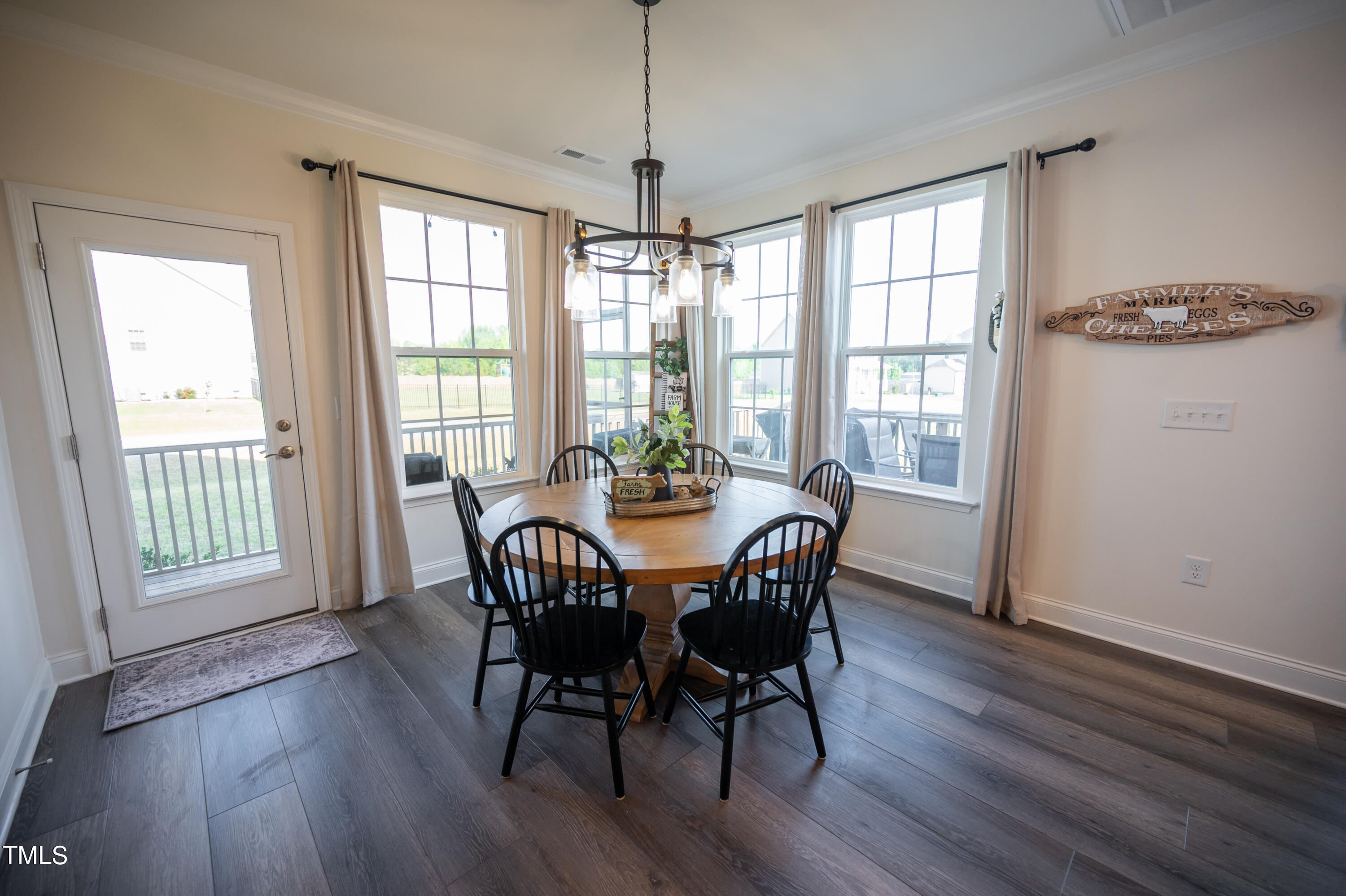 357 Sunrise Ridge Drive Willow Spring, NC 27592 - Photo 10 of 35 a view of a dining room with furniture window and wooden floor