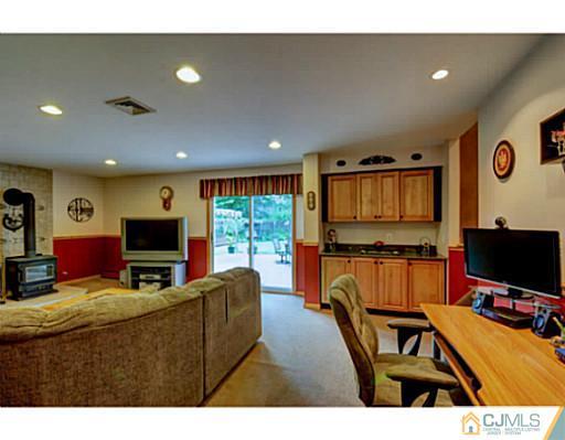 15 Warwick Road Edison, NJ 08820 - Photo 14 of 25 a living room with furniture and a flat screen tv