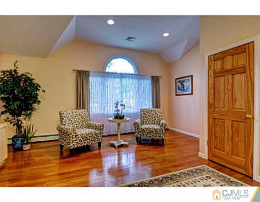 15 Warwick Road Edison, NJ 08820 - Photo 22 of 25 a living room with furniture and a potted plant