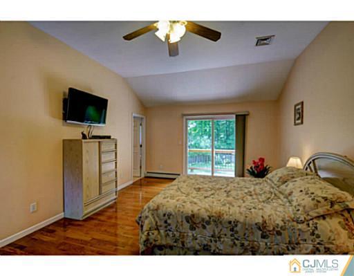 15 Warwick Road Edison, NJ 08820 - Photo 23 of 25 a bedroom with a bed and a flat screen tv