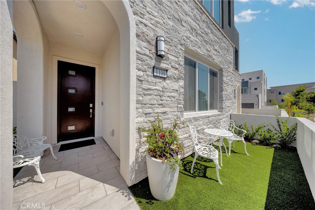 1109 Cadence Irvine, CA 92618 - Photo 2 of 12 a view of a porch with chairs and potted plants