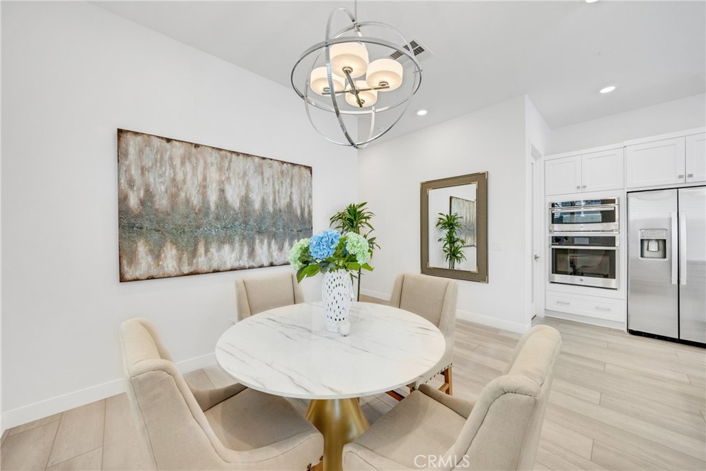 1109 Cadence Irvine, CA 92618 - Photo 5 of 12 a view of a dining room with furniture a livingroom and chandelier