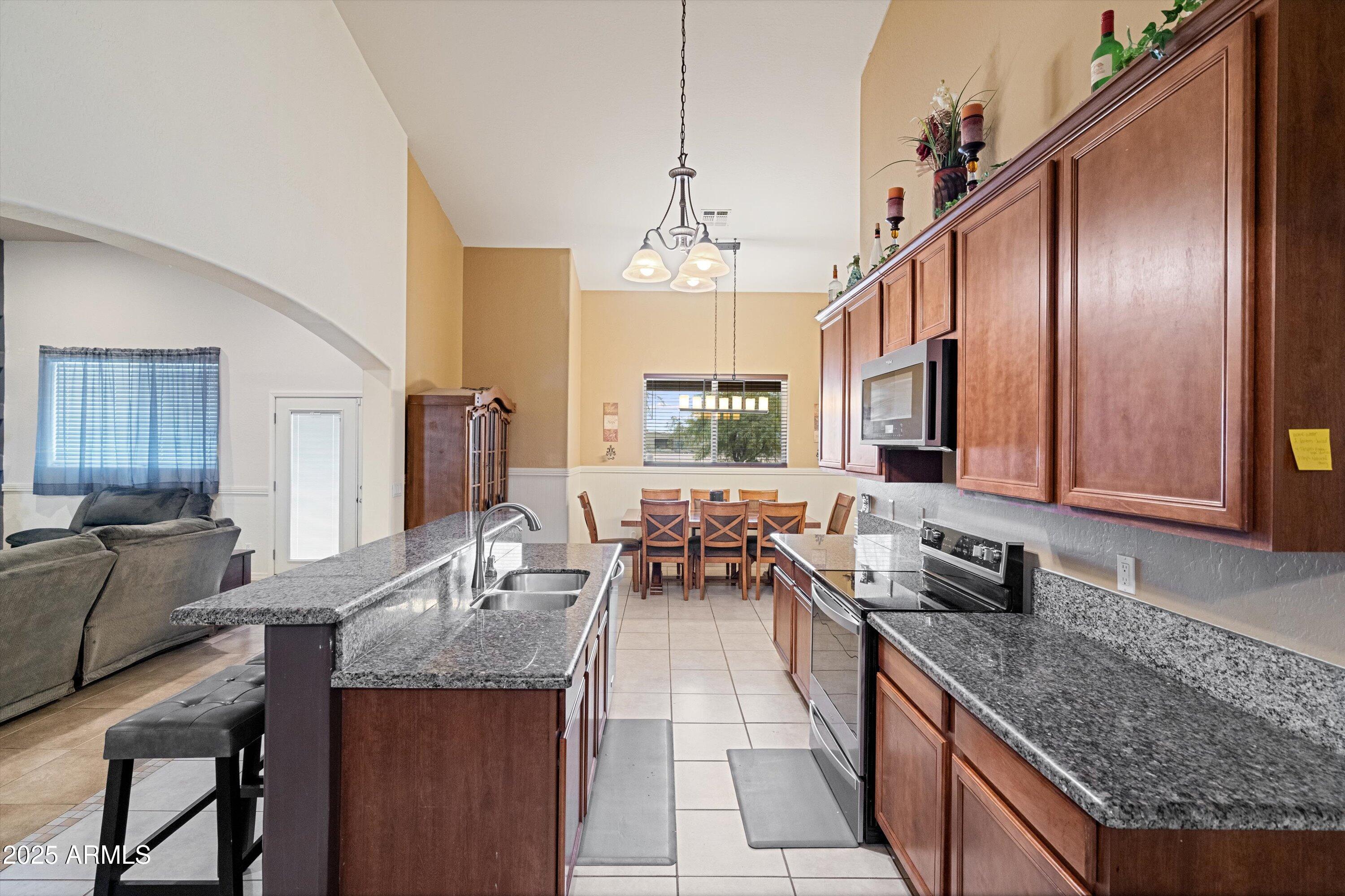 35947 West Buckeye Road Tonopah, AZ 85354 - Photo 17 of 54 a kitchen with granite countertop lots of counter top space and stainless steel appliances