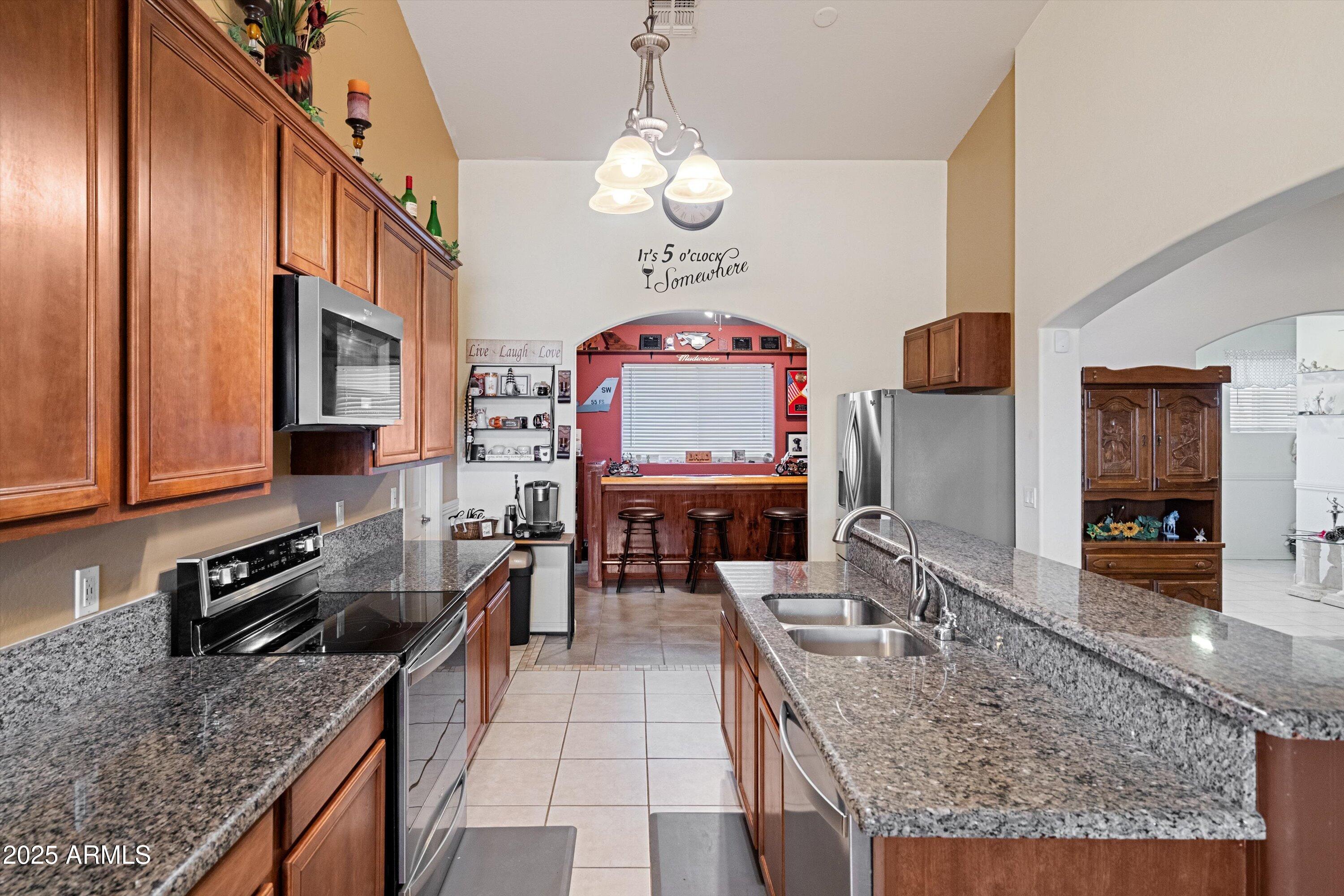 35947 West Buckeye Road Tonopah, AZ 85354 - Photo 18 of 54 a kitchen with stainless steel appliances granite countertop a stove oven and a counter space