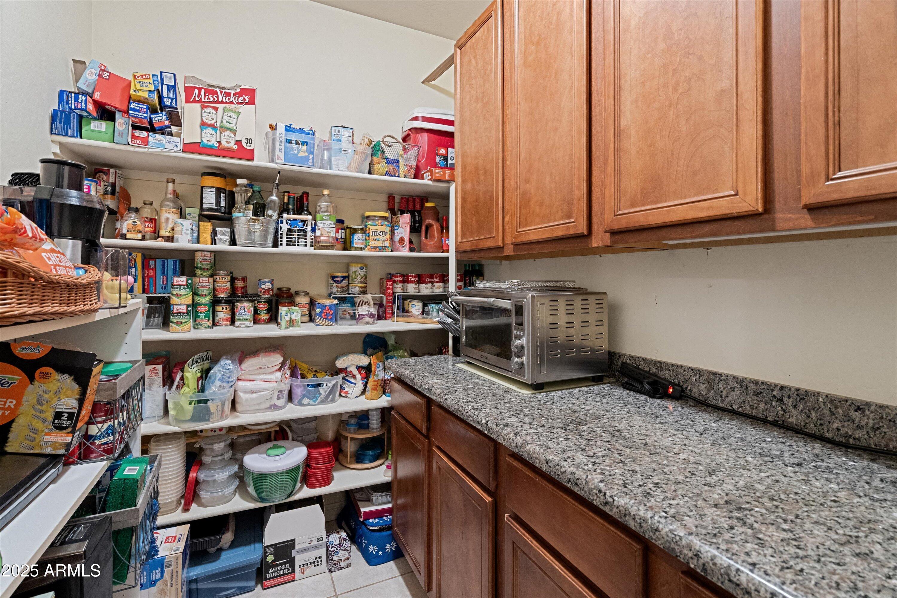 35947 West Buckeye Road Tonopah, AZ 85354 - Photo 20 of 54 a kitchen with granite countertop lots of different kinds of food