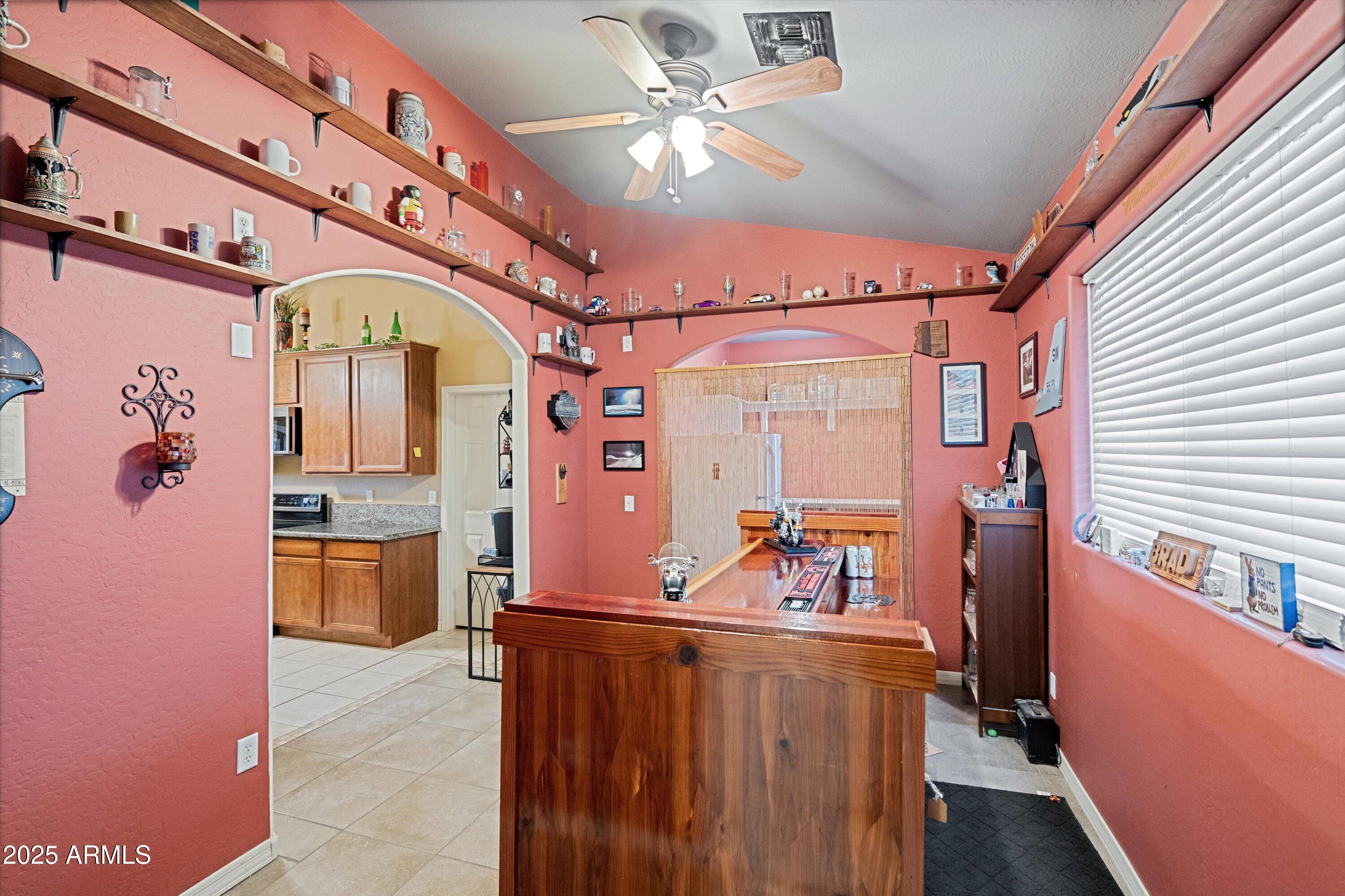 35947 West Buckeye Road Tonopah, AZ 85354 - Photo 24 of 54 a view of a hallway with a dining table & chairs