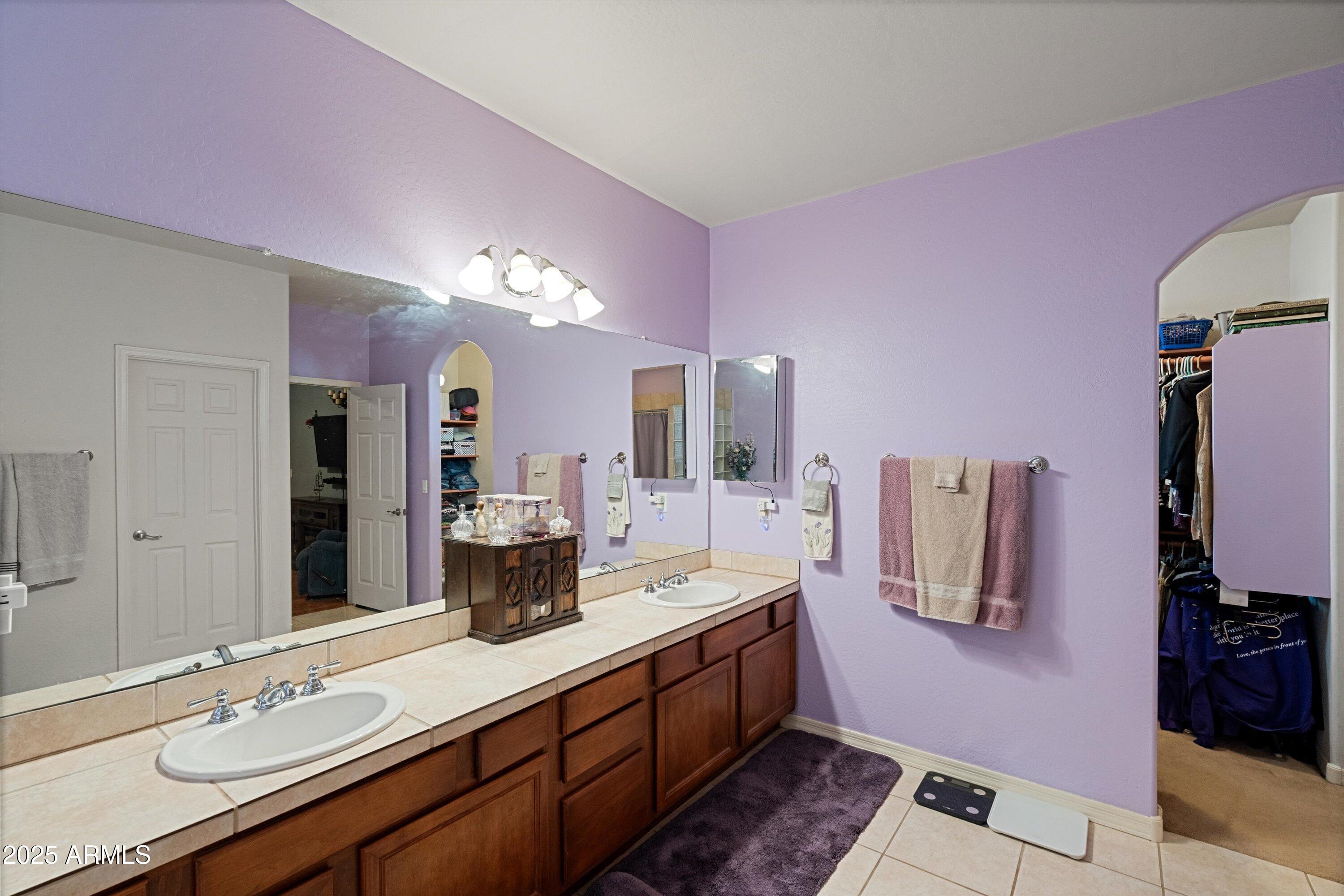 35947 West Buckeye Road Tonopah, AZ 85354 - Photo 28 of 54 a spacious bathroom with a granite countertop sink a mirror and vanity