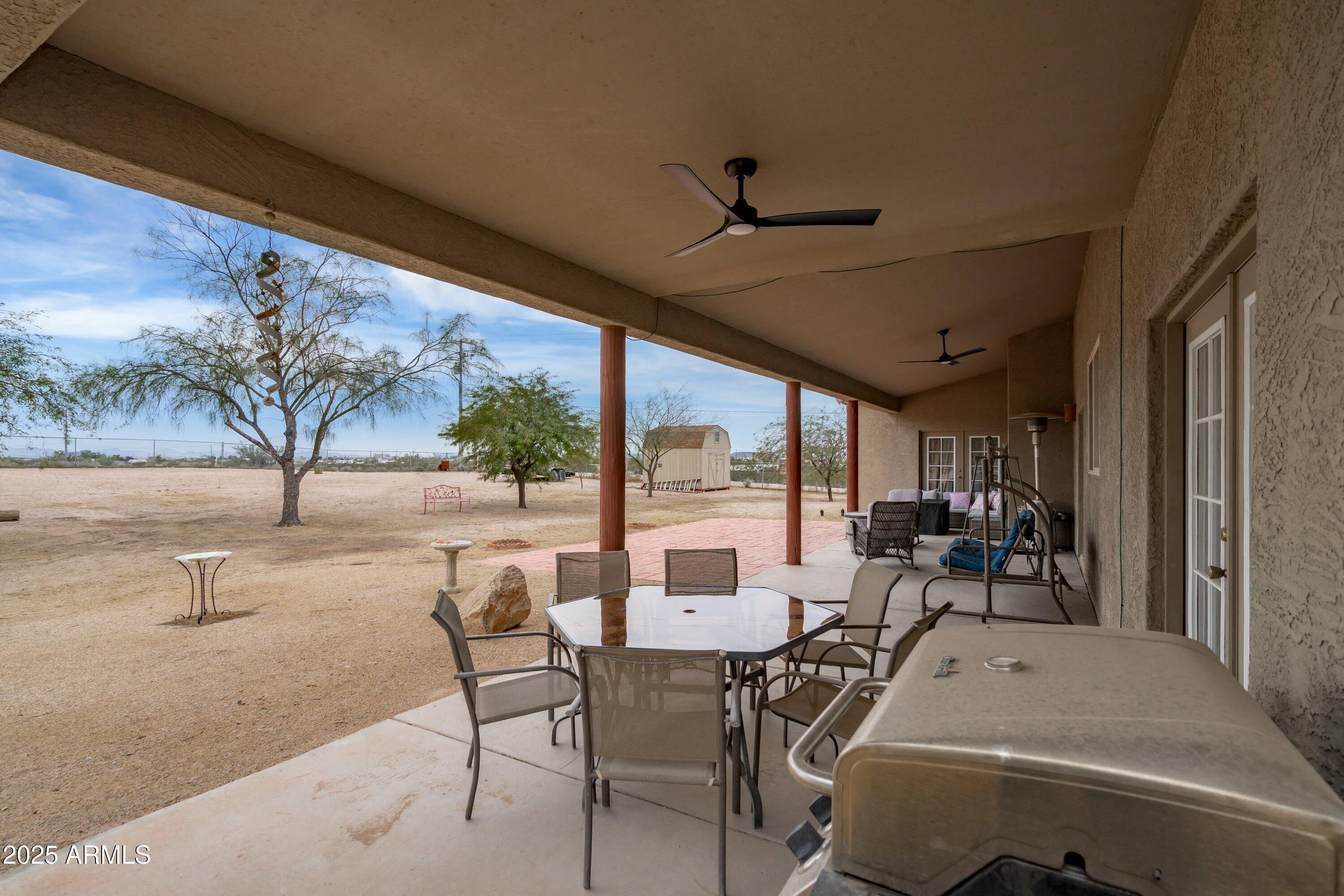 35947 West Buckeye Road Tonopah, AZ 85354 - Photo 37 of 54 a view of a patio with table and chairs and potted plants