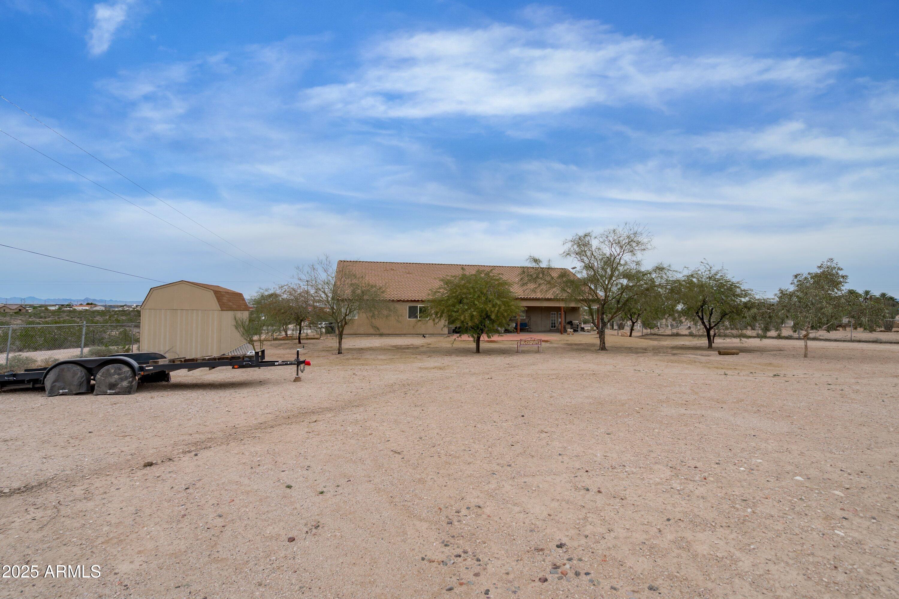 35947 West Buckeye Road Tonopah, AZ 85354 - Photo 44 of 54 a view of a dry yard with wooden fence