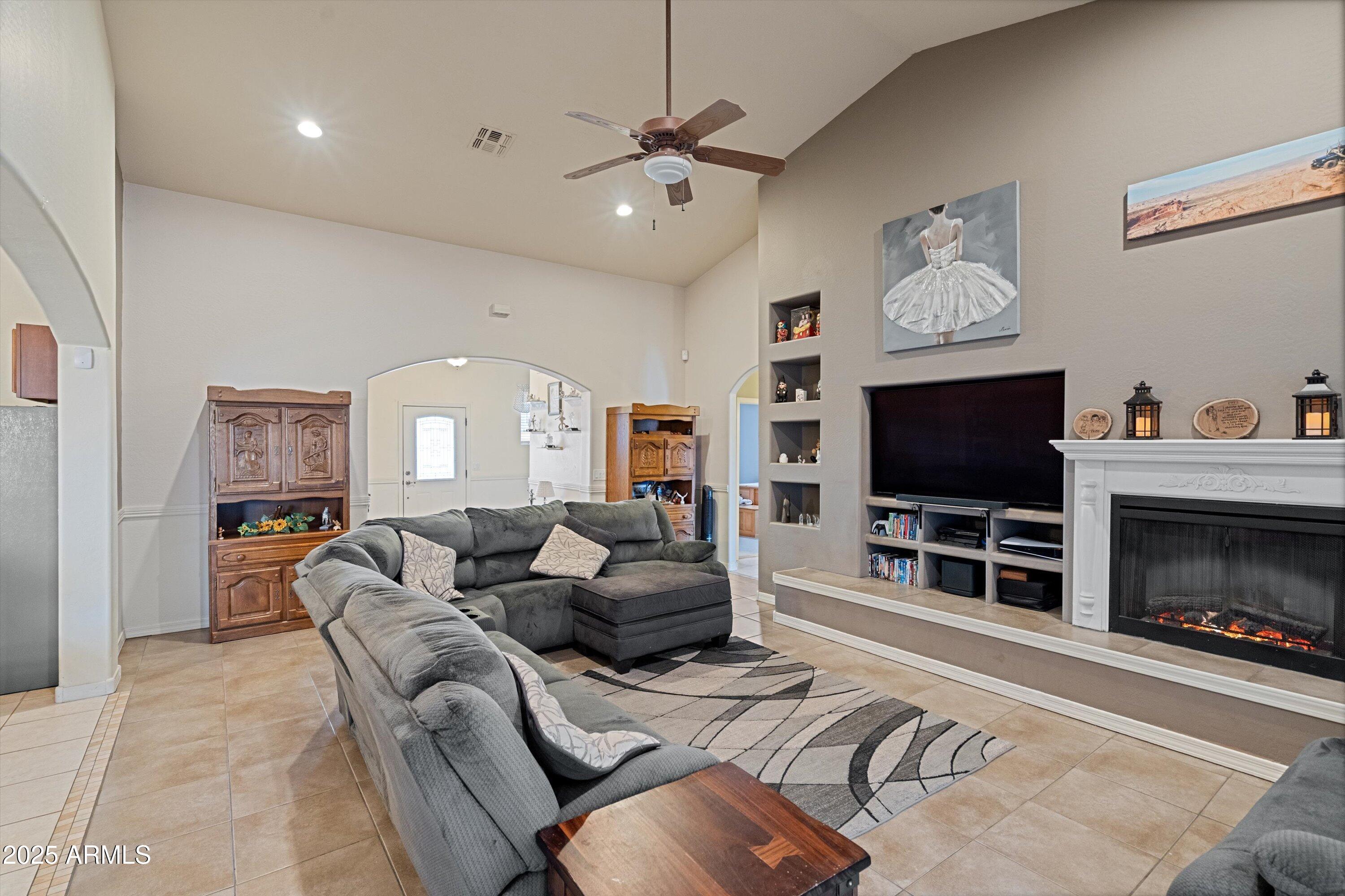 35947 West Buckeye Road Tonopah, AZ 85354 - Photo 10 of 54 a living room with furniture and a flat screen tv