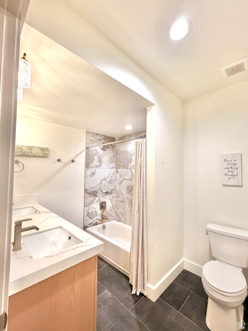 3626 Riverstone Road Mapleton, UT 84664 - Photo 45 of 58 Full bathroom featuring double vanity, shower / bath combo, and dark tile patterned floors