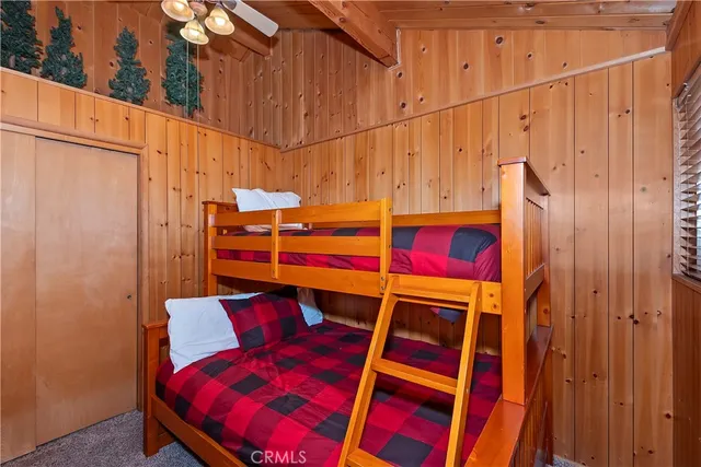 a view of a room with a bed and furniture