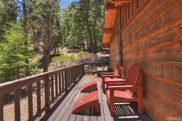 a view of a house with a large tree and a yard