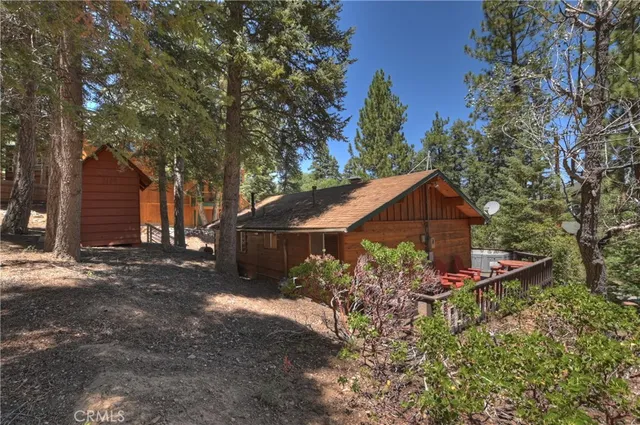 a front view of a house with a yard and trees