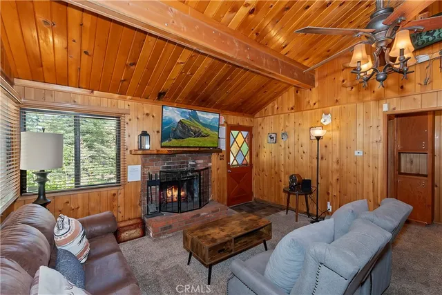 a living room with furniture a fireplace and a table
