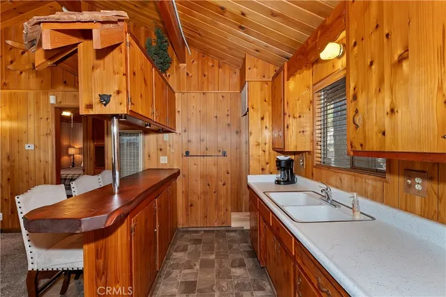 a kitchen that has a sink and a wooden floor