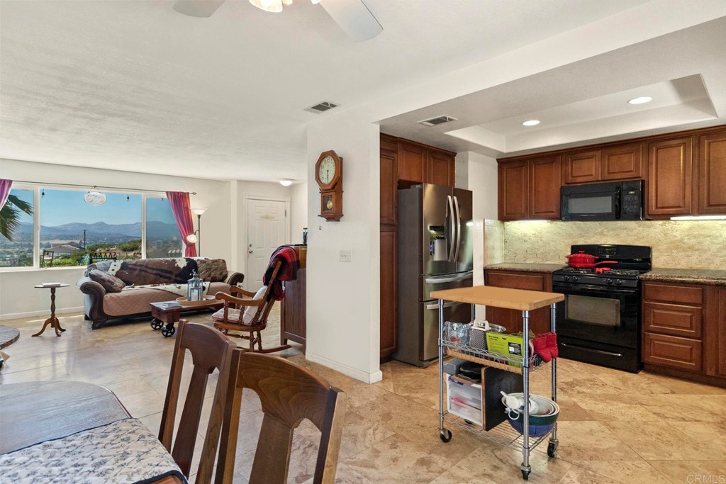 1104 Doomey Drive Ramona, CA 92065 - Photo 13 of 31 a living room with furniture a kitchen view and a wooden floor