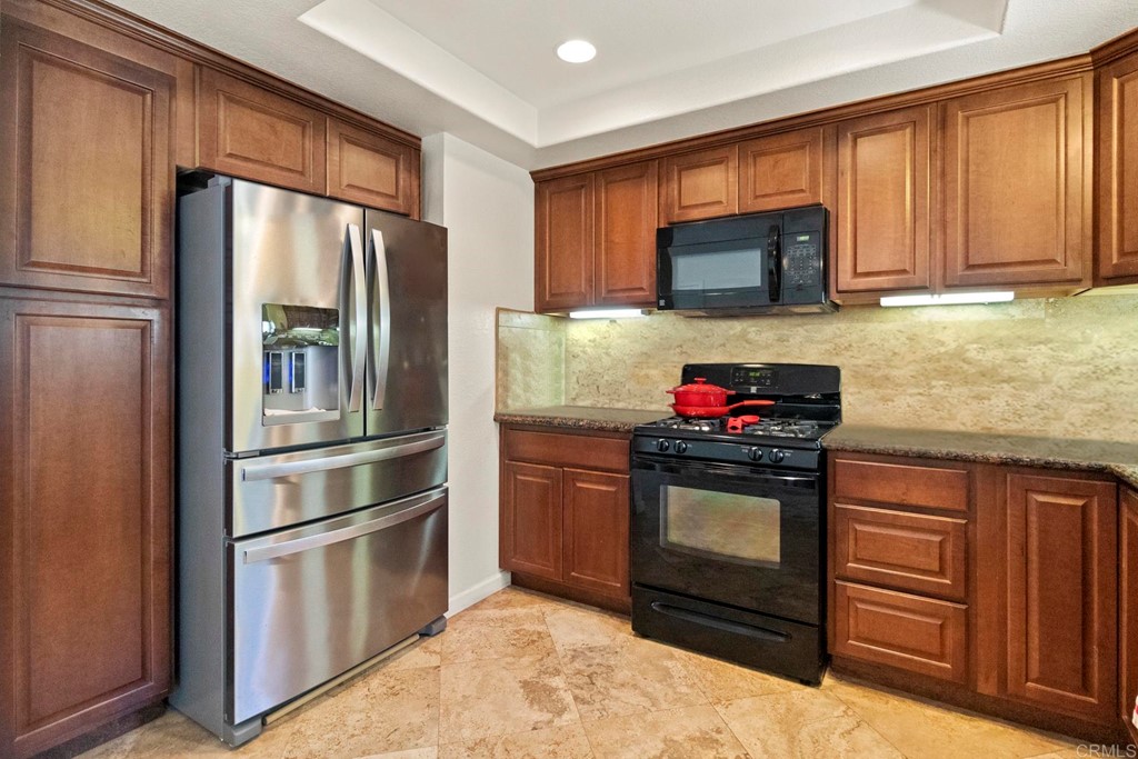 1104 Doomey Drive Ramona, CA 92065 - Photo 15 of 31 a kitchen with granite countertop stainless steel appliances and wooden cabinets