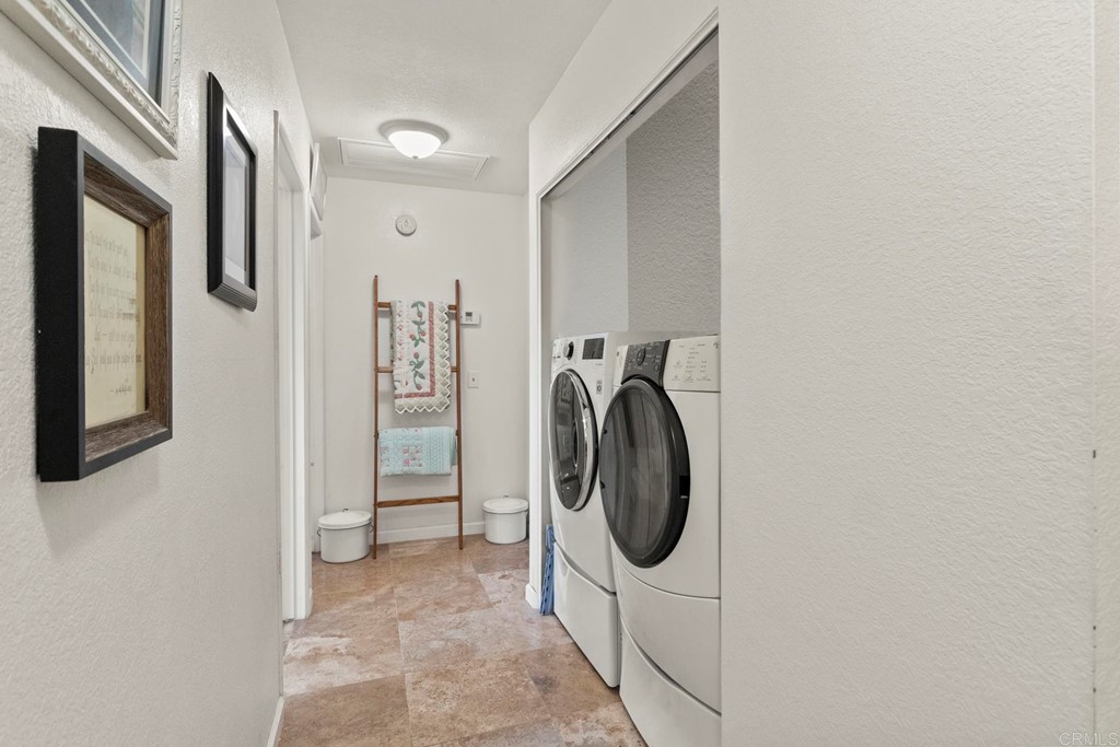 1104 Doomey Drive Ramona, CA 92065 - Photo 19 of 31 a view of a hallway with washer and dryer