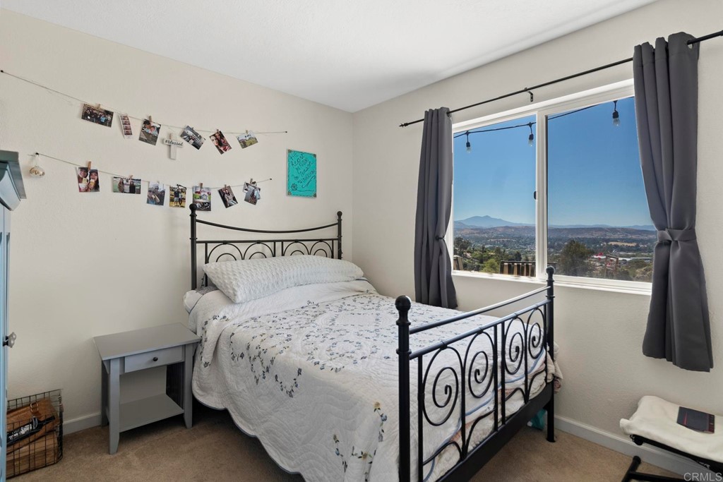 1104 Doomey Drive Ramona, CA 92065 - Photo 21 of 31 a bedroom with a bed and a window