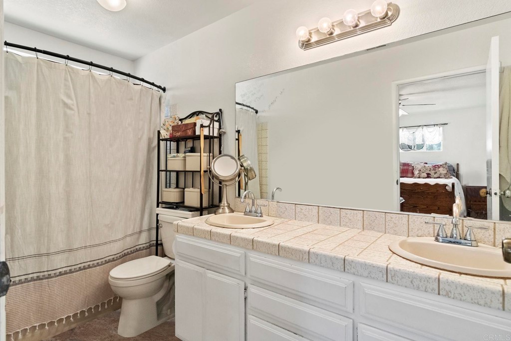 1104 Doomey Drive Ramona, CA 92065 - Photo 25 of 31 a bathroom with a sink toilet and shower