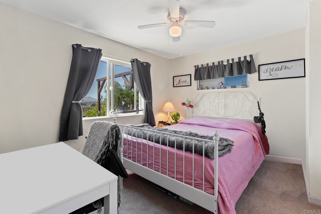 1104 Doomey Drive Ramona, CA 92065 - Photo 26 of 31 a bedroom with a bed wooden floor and window