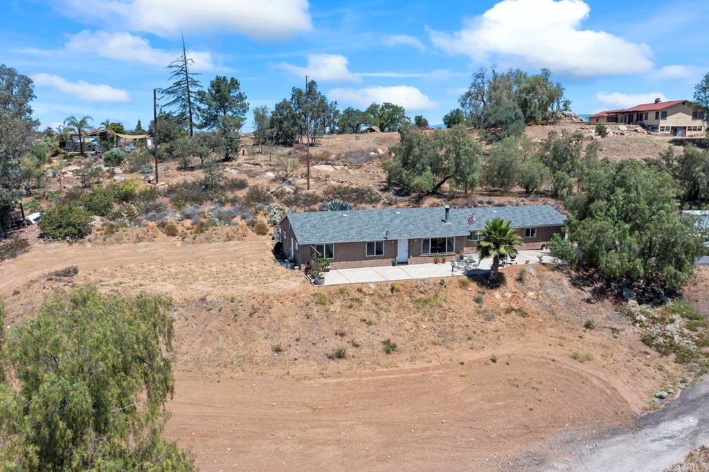 1104 Doomey Drive Ramona, CA 92065 - Photo 30 of 31 a view of a house with a yard