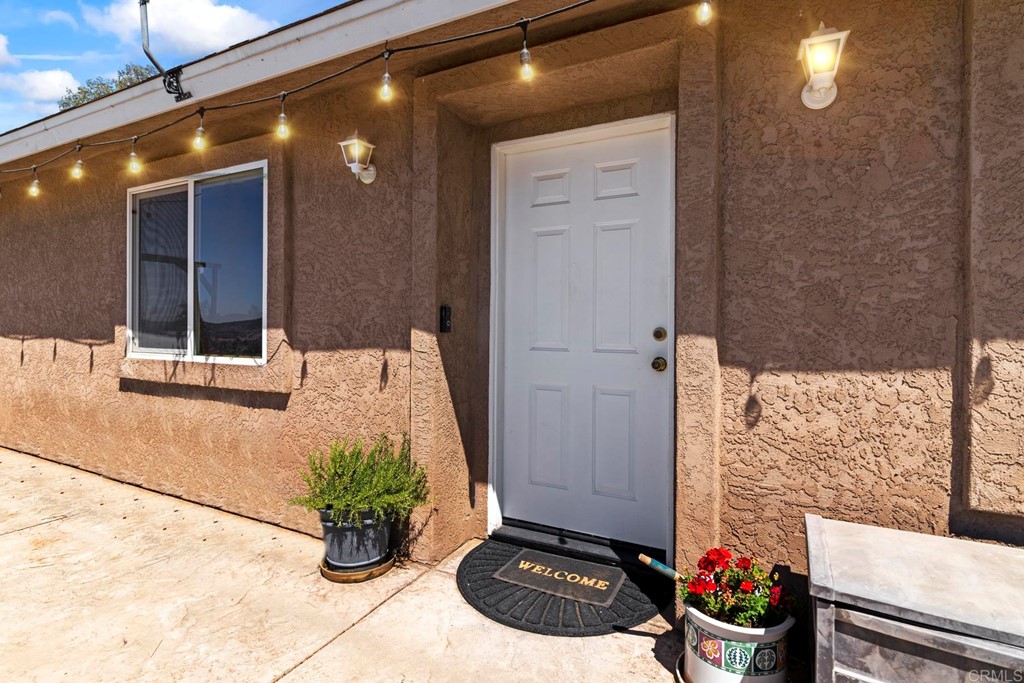 1104 Doomey Drive Ramona, CA 92065 - Photo 4 of 31 a vase of flowers sitting on a floor